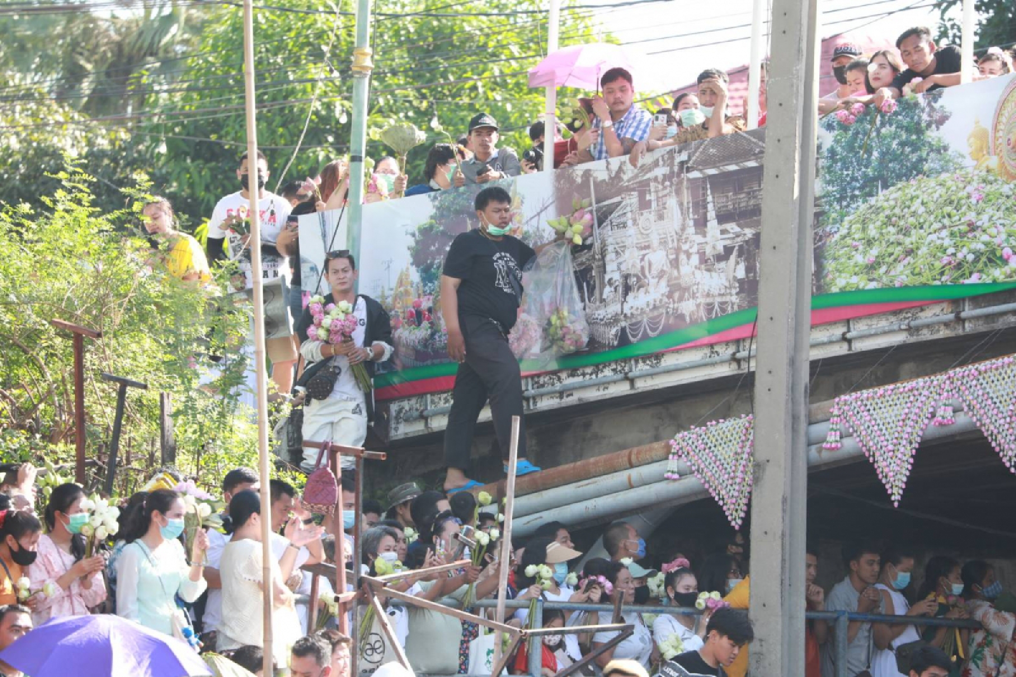 Buddhist devotees come together for lotus-throwing fest despite restrictions