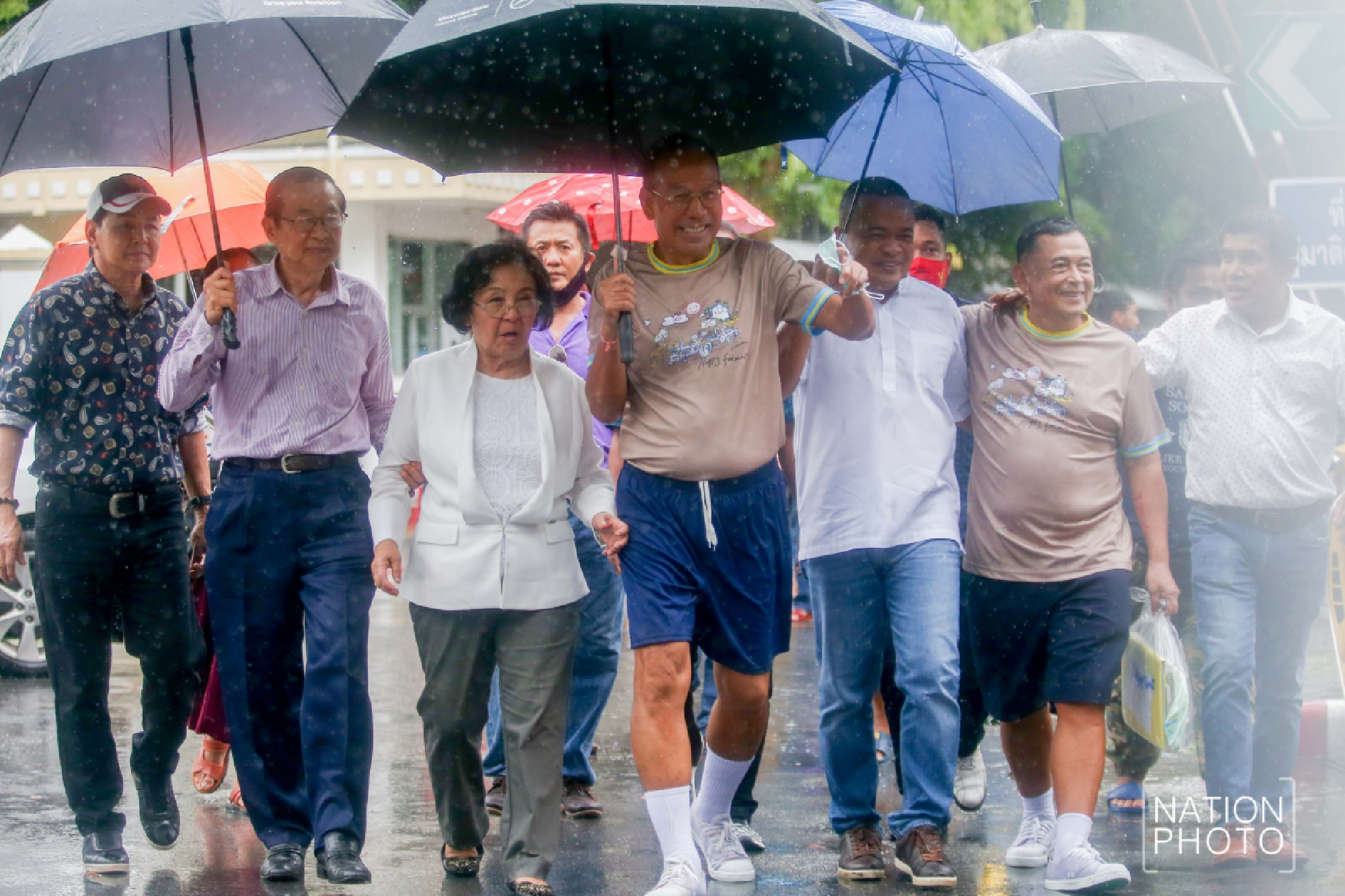 Red shirts greet activists freed from prison after royal pardon