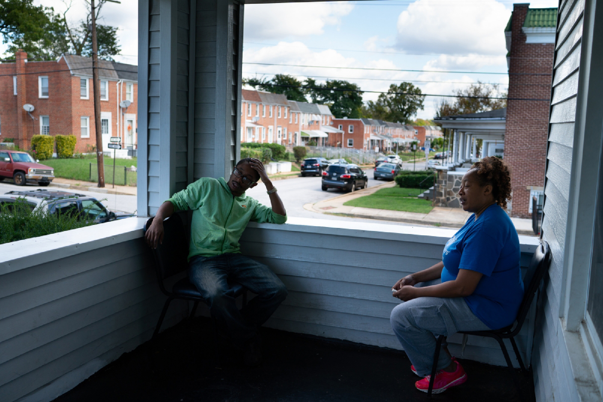 Donnelle Boone, 21, and Patricia Williams, 51, sit on their porch. Williams said her family used to "make $500 parking cars on race day." MUST CREDIT: Washington Post photo by Sarah L. Voisin.