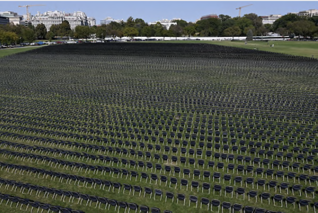 With the White House in the background, 20,000 chairs, each representing 1,000 deaths from the coronavirus pandemic in the United States are lined up on the Ellipse for a remembrance event Sunday, Oct. 4, 2020. MUST CREDIT: Washington Post photo by Katherine Frey