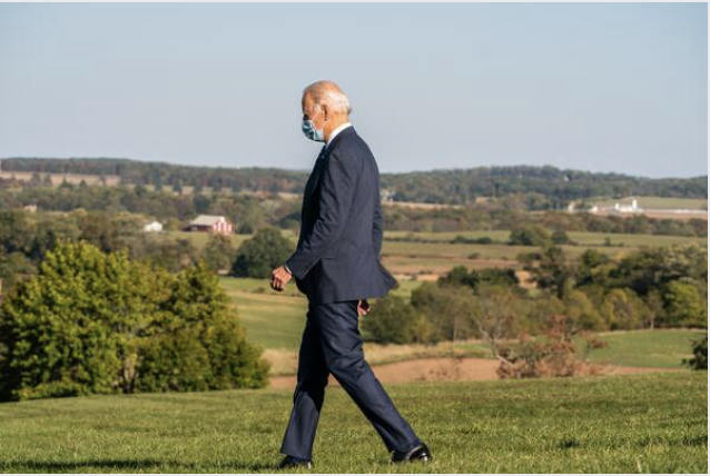 Joe Biden makes his way to the podium Tuesday in Gettysburg, Pa. He urged the nation to "revive the spirit of bipartisanship." MUST CREDIT: Washington Post photo by Demetrius Freeman