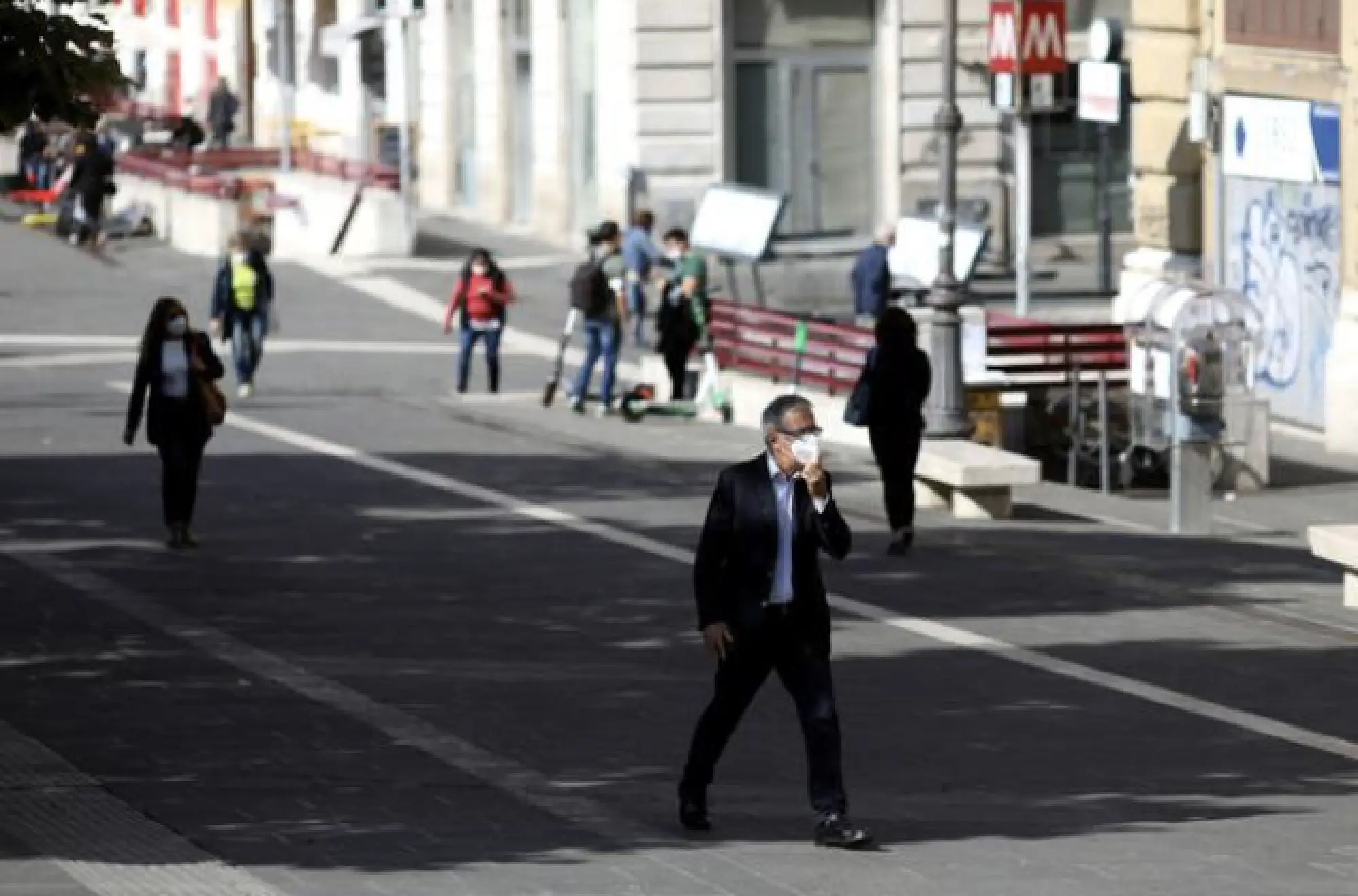 Pedestrians wearing protective face masks cross a road in Rome on Oct. 1, 2020. MUST CREDIT: Bloomberg photo by Alessia Pierdomenico.