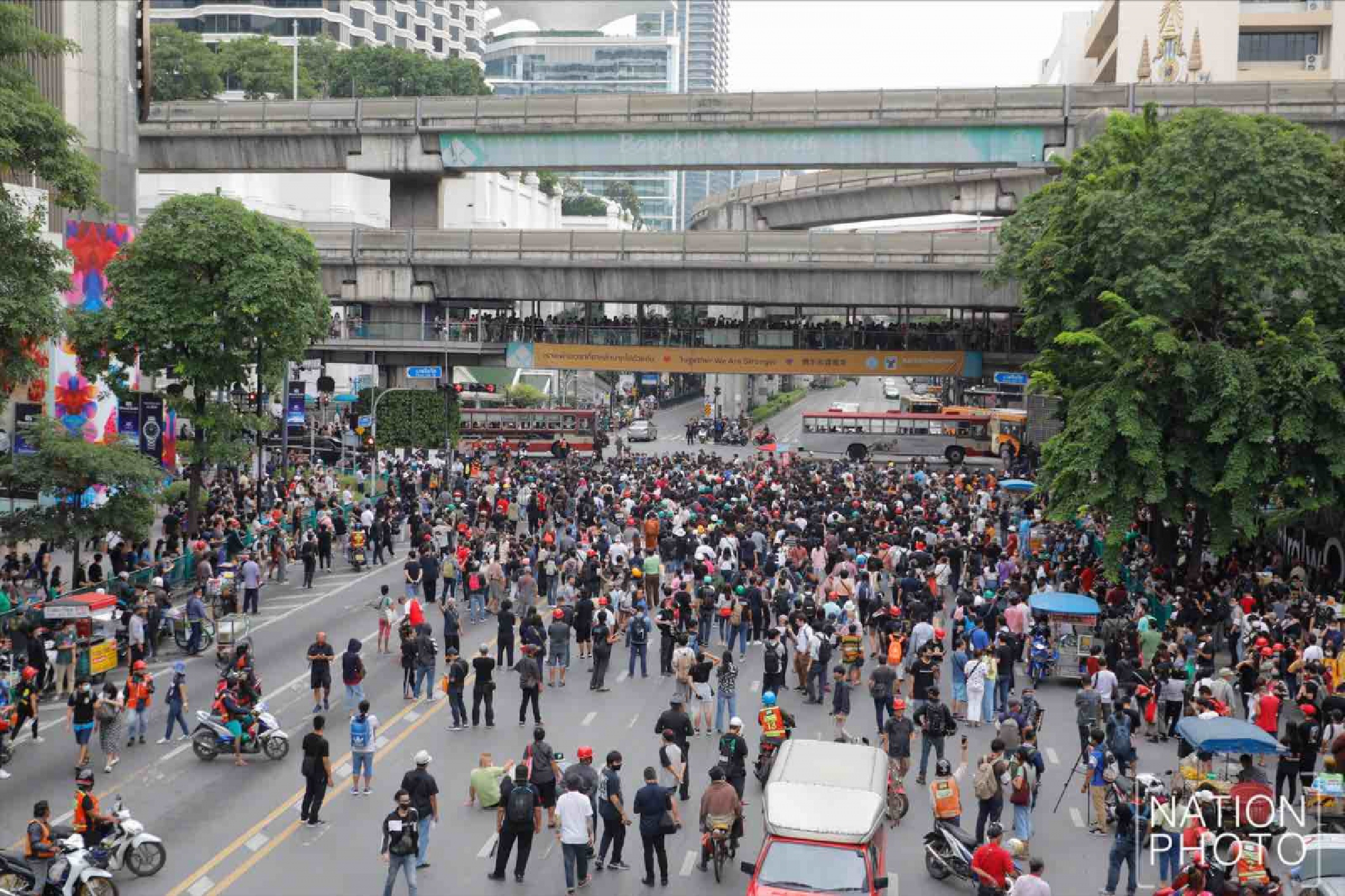 Protesters gather at Ratchaprasong intersection, royalists hold portraits of Thai kings