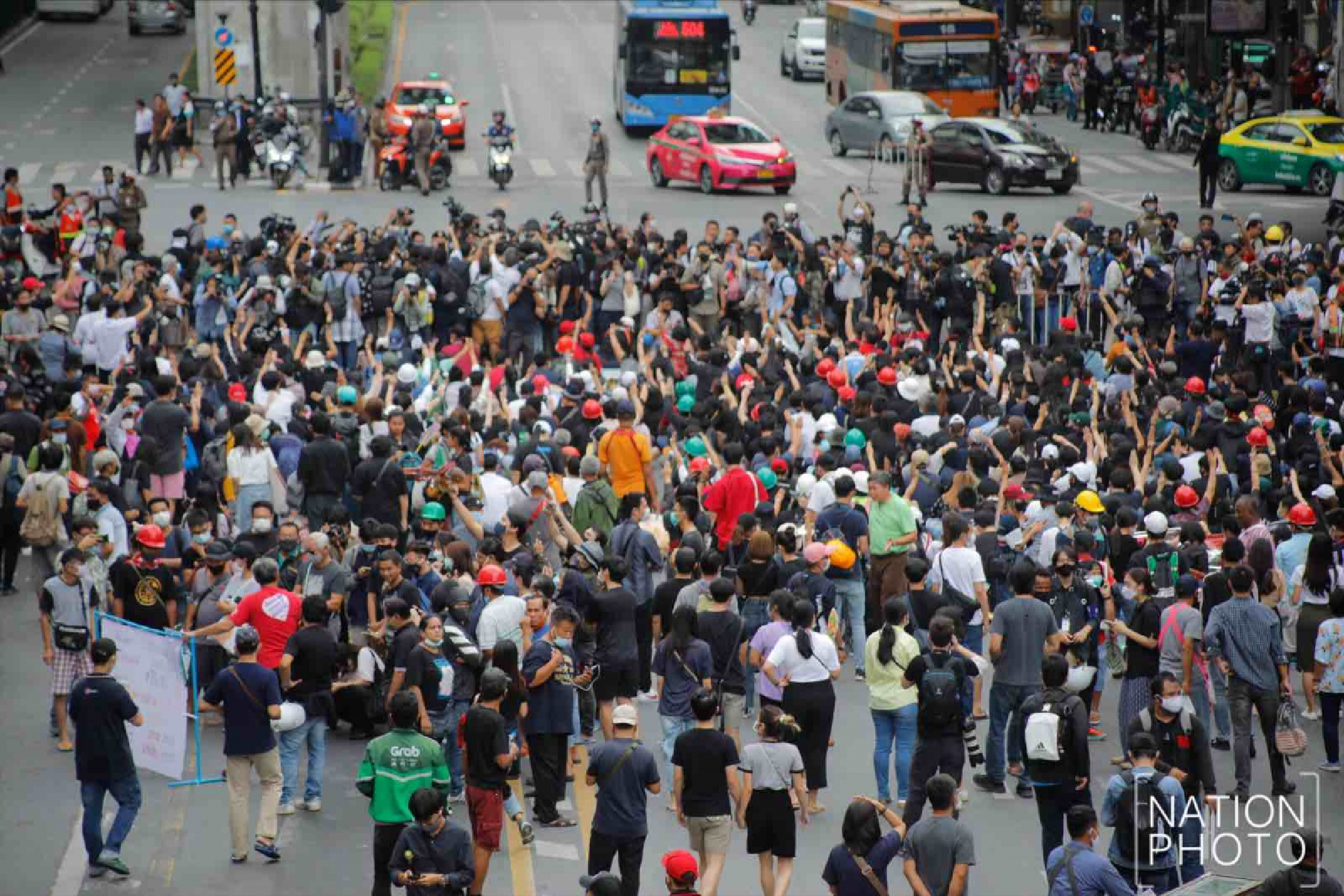Protesters gather at Ratchaprasong intersection, royalists hold portraits of Thai kings