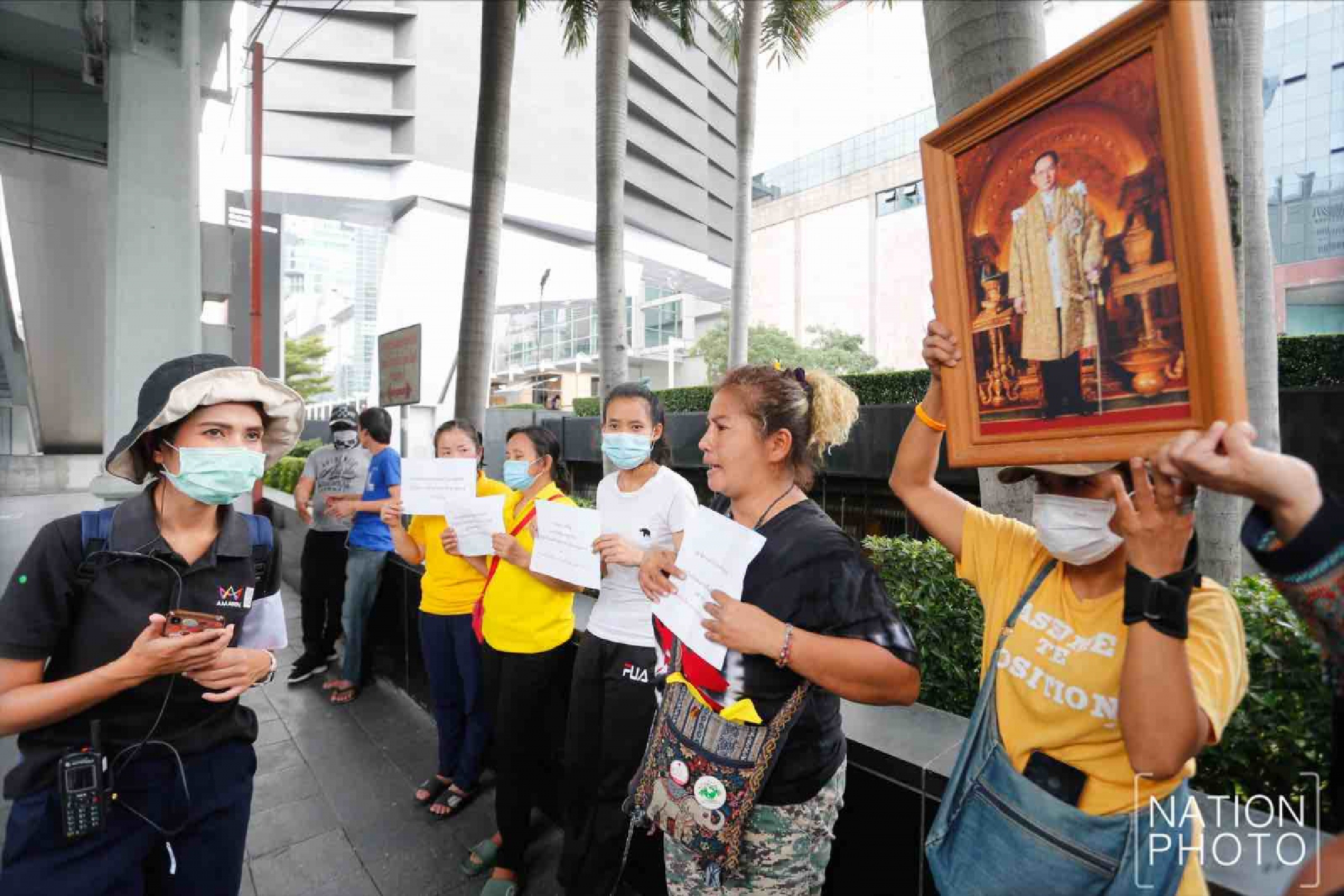 Protesters gather at Ratchaprasong intersection, royalists hold portraits of Thai kings
