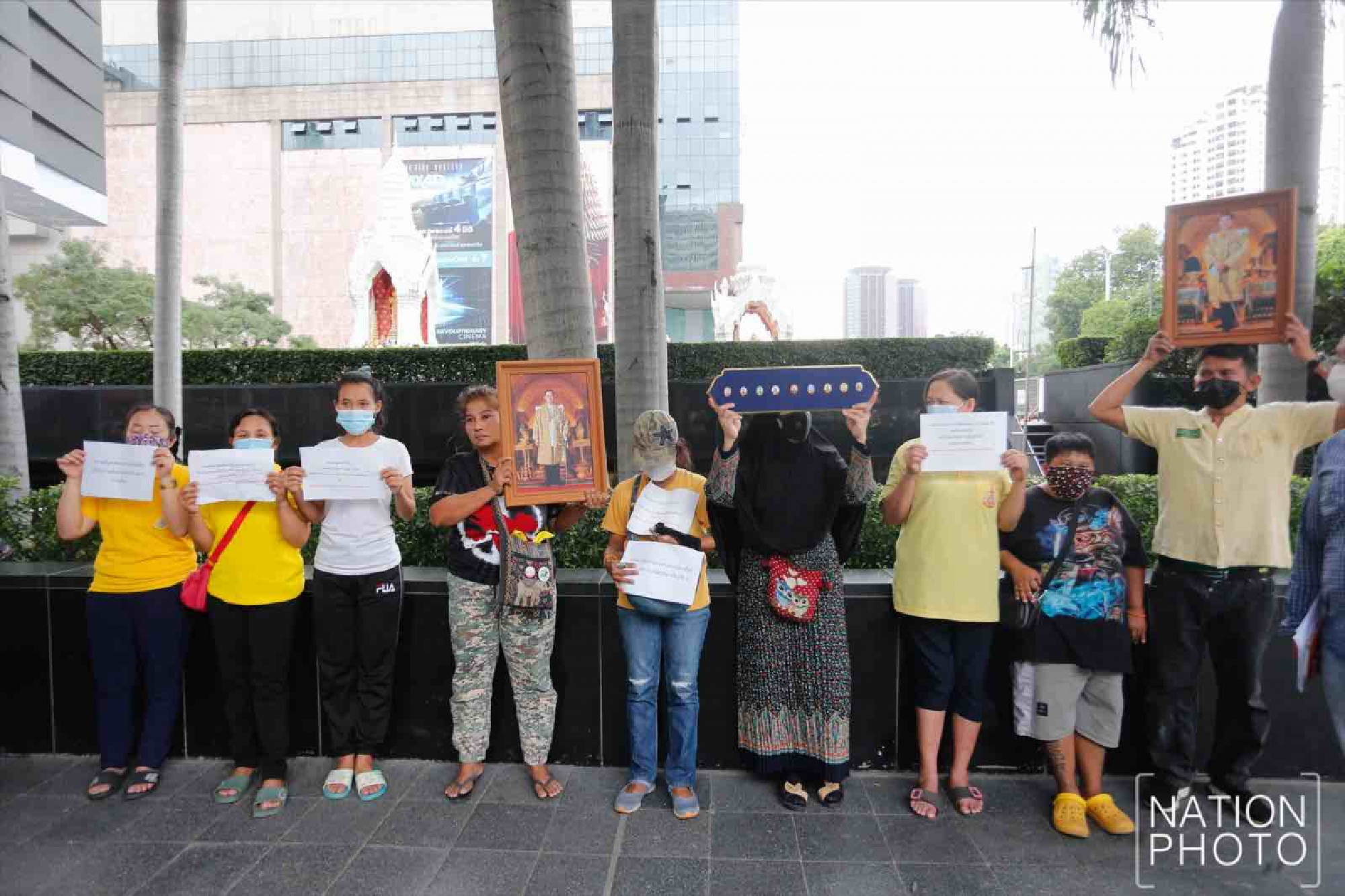 Protesters gather at Ratchaprasong intersection, royalists hold portraits of Thai kings