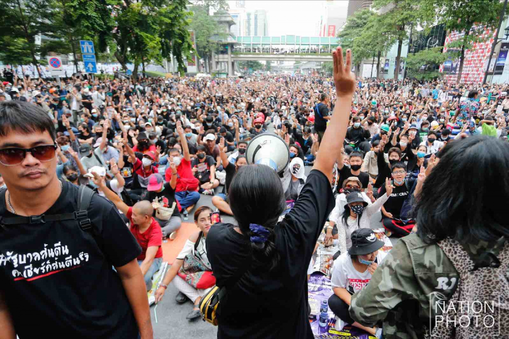 Protesters gather at Ratchaprasong intersection, royalists hold portraits of Thai kings