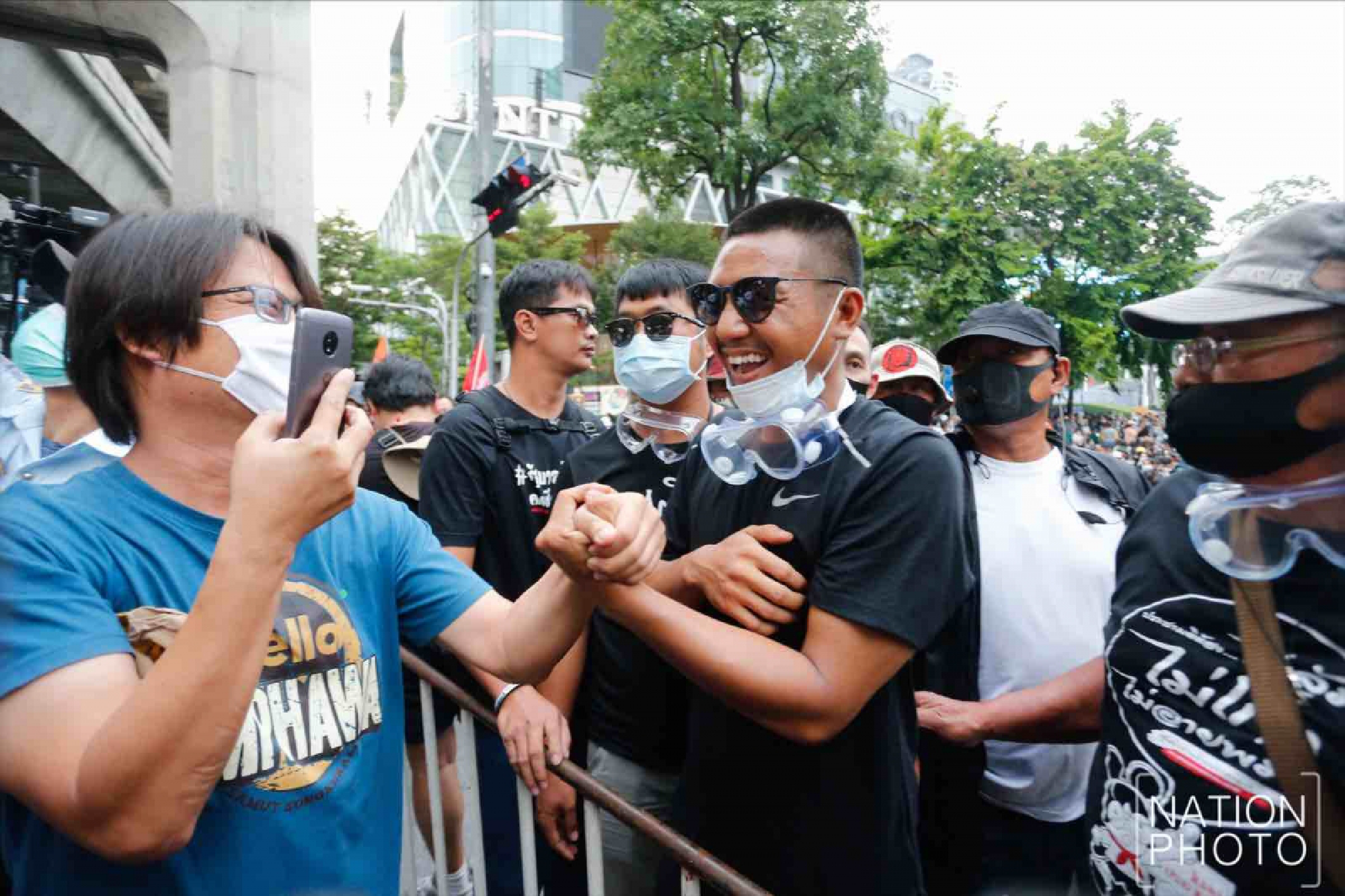 Protesters gather at Ratchaprasong intersection, royalists hold portraits of Thai kings