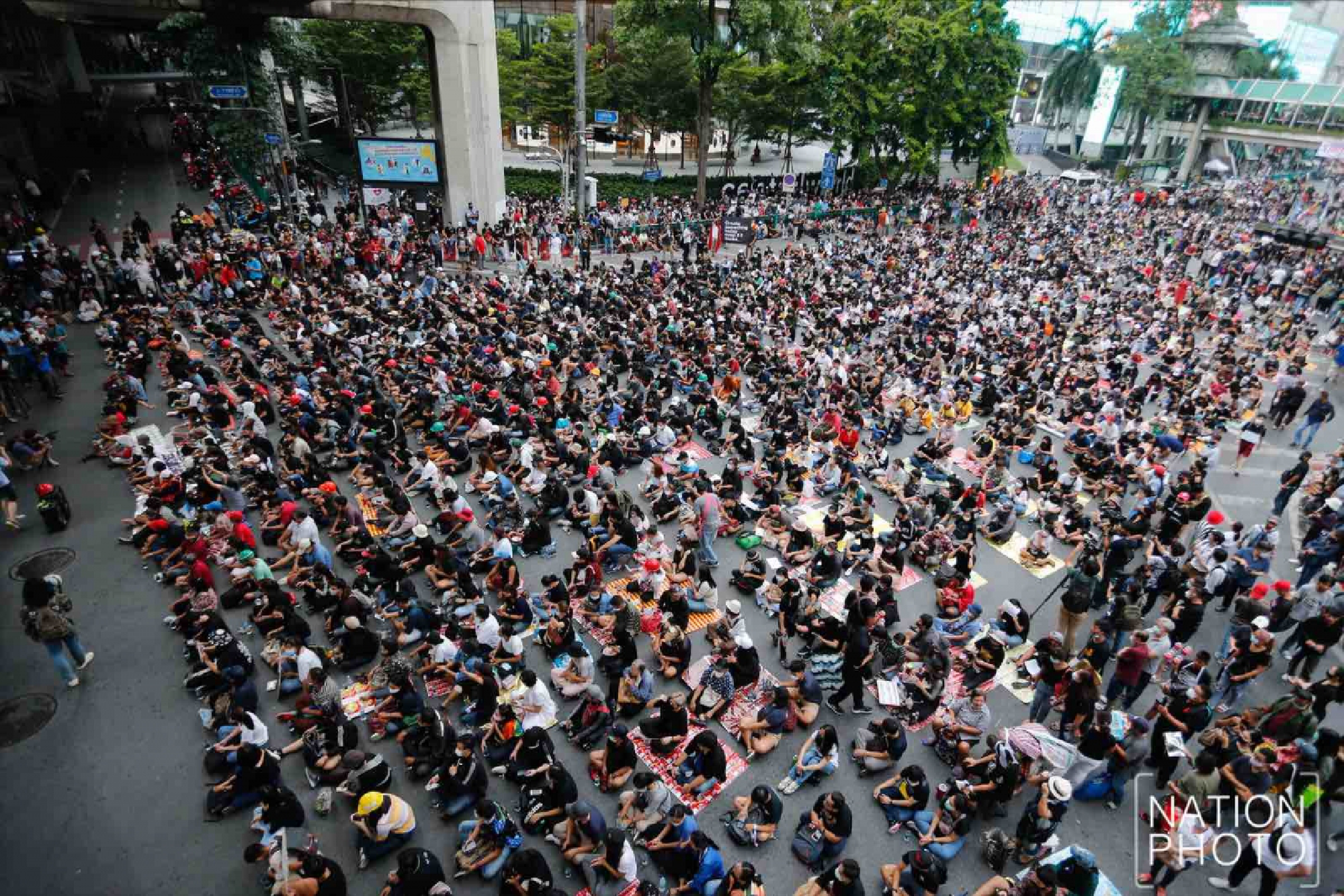 Protesters gather at Ratchaprasong intersection, royalists hold portraits of Thai kings