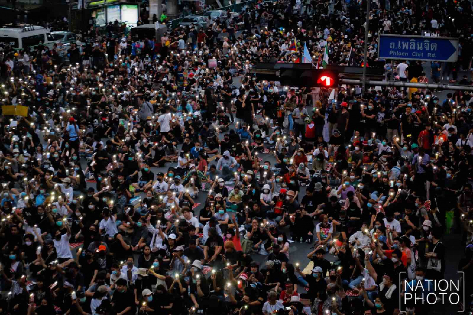 Protesters gather at Ratchaprasong intersection, royalists hold portraits of Thai kings
