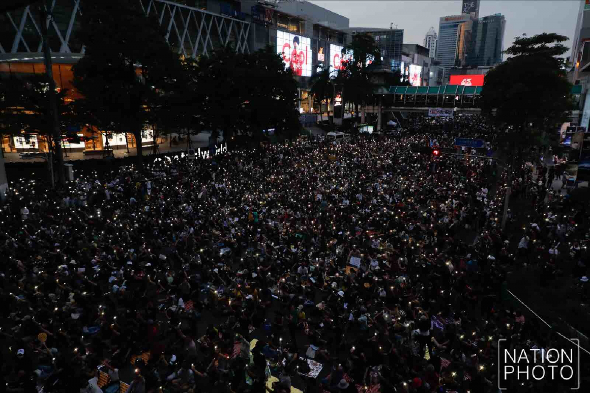 Protesters gather at Ratchaprasong intersection, royalists hold portraits of Thai kings