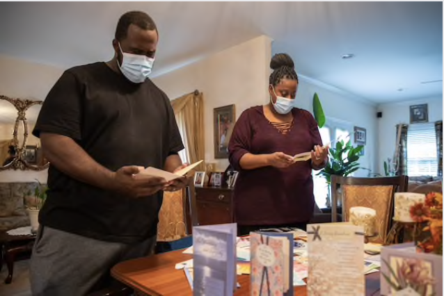 Carlton Coates Jr. and Juanette Long-Coates sort out condolence cards after his sister, Carol, and his mother, Dale, died of covid-19 just days apart. MUST CREDIT: Photo by Amanda Andrade-Rhoades for The Washington Post