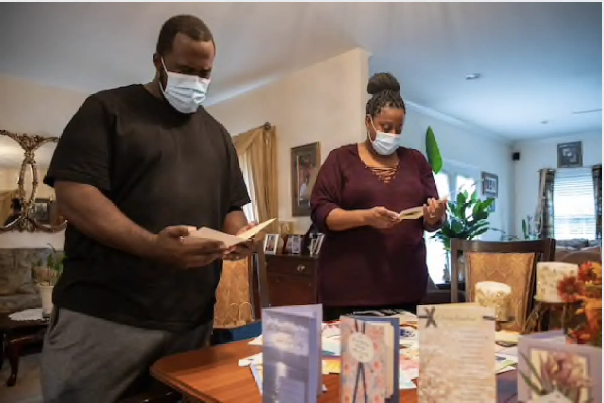 Carlton Coates Jr. and Juanette Long-Coates sort out condolence cards after his sister, Carol, and his mother, Dale, died of covid-19 just days apart. MUST CREDIT: Photo by Amanda Andrade-Rhoades for The Washington Post