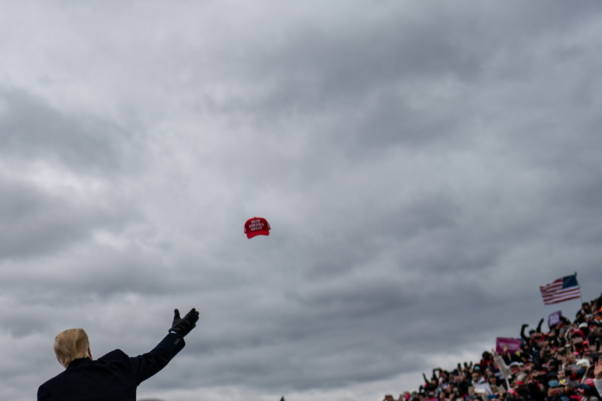 President Donald Trump throws a hat to supporters during a rally in Waterford Township, Mich. on Friday. MUST CREDIT: Washington Post photo by Salwan Georges Photo by: Salwan Georges — The Washington Post Location: Waterford Township United States