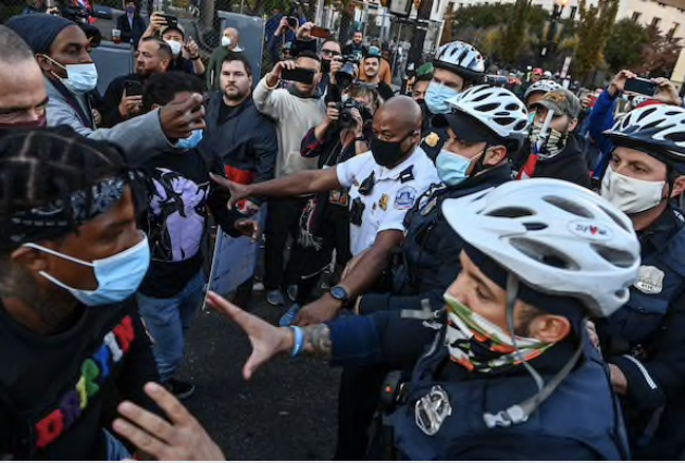 Police break up a scuffle between anti-Trump and pro-Trump demonstrators at Black Lives Matter Plaza on Friday. MUST CREDIT: Washington Post photo by Ricky Carioti