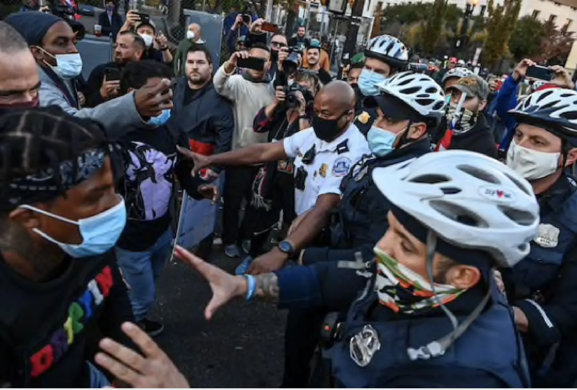 Police break up a scuffle between anti-Trump and pro-Trump demonstrators at Black Lives Matter Plaza on Friday. MUST CREDIT: Washington Post photo by Ricky Carioti