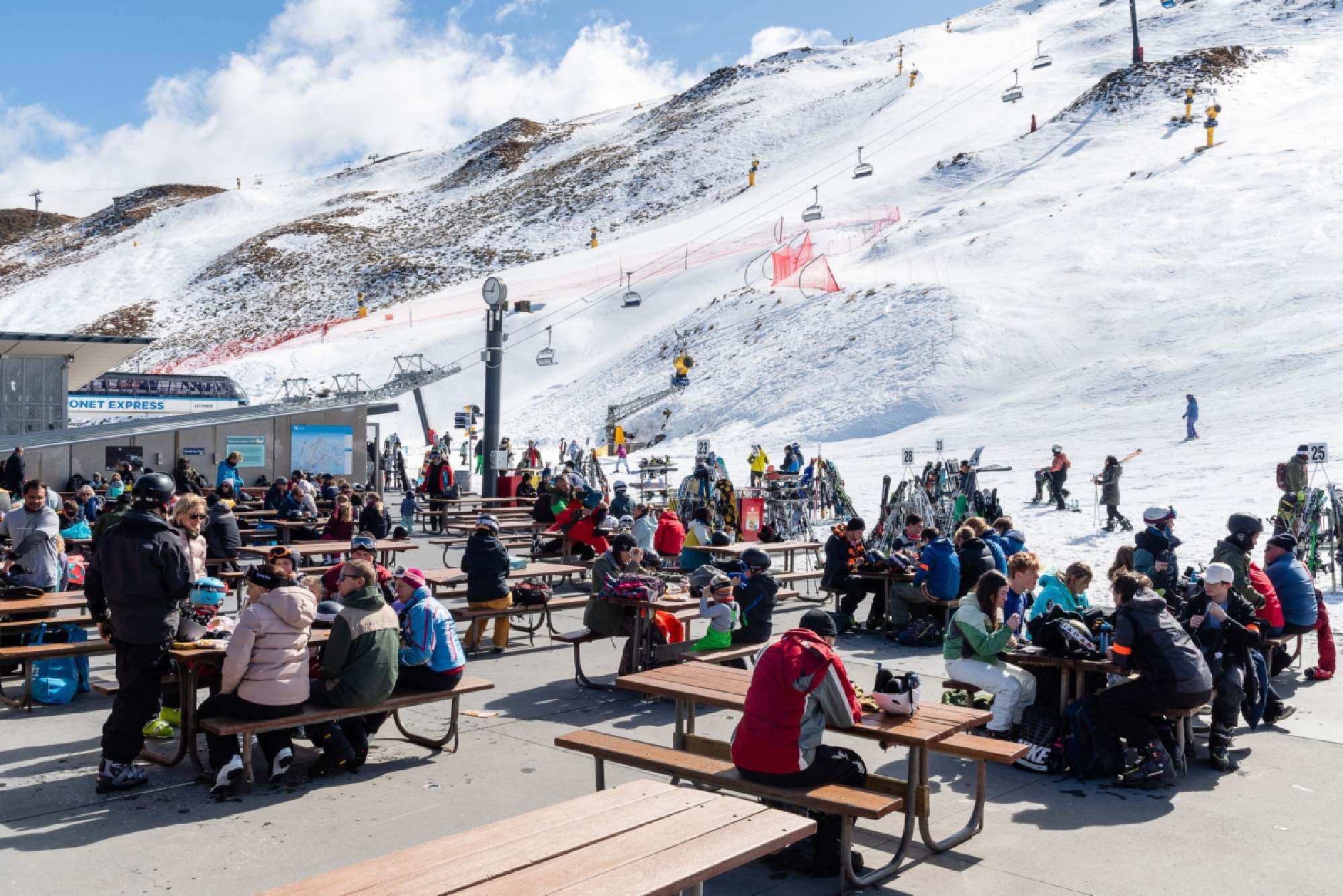 People sit at tables at the Coronet Peak ski field near Queenstown, New Zealand, on Sept. 10, 2020. MUST CREDIT: Bloomberg photo by Mark Coote