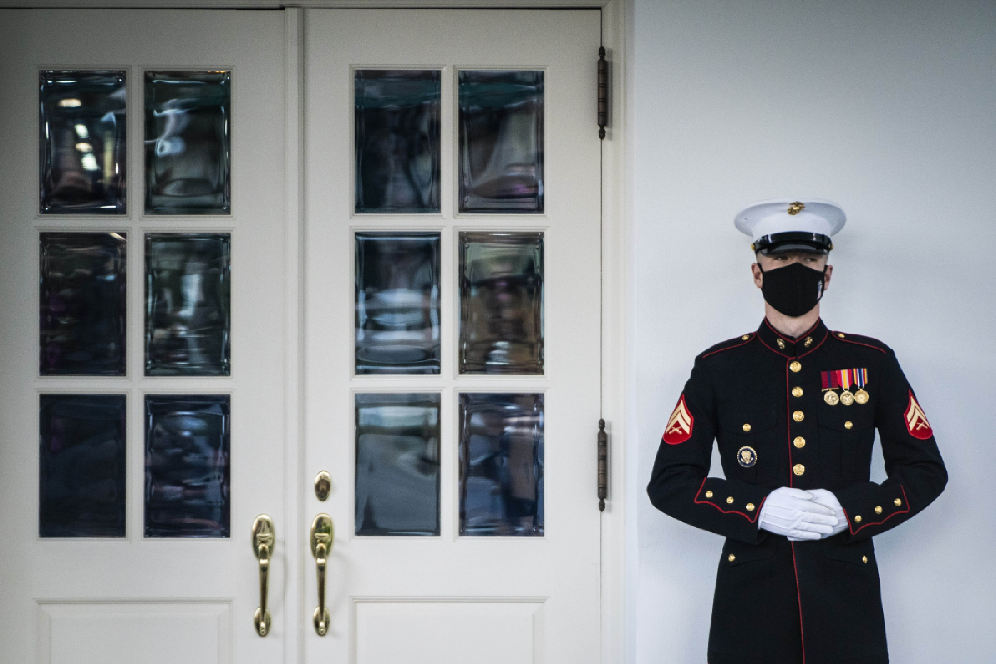 A Marine stands guard outside the West Wing doors, signifying that President Donald Trump is in the Oval Office on Tuesday, Nov. 17, 2020. MUST CREDIT: Washington Post photo by Jabin Botsford