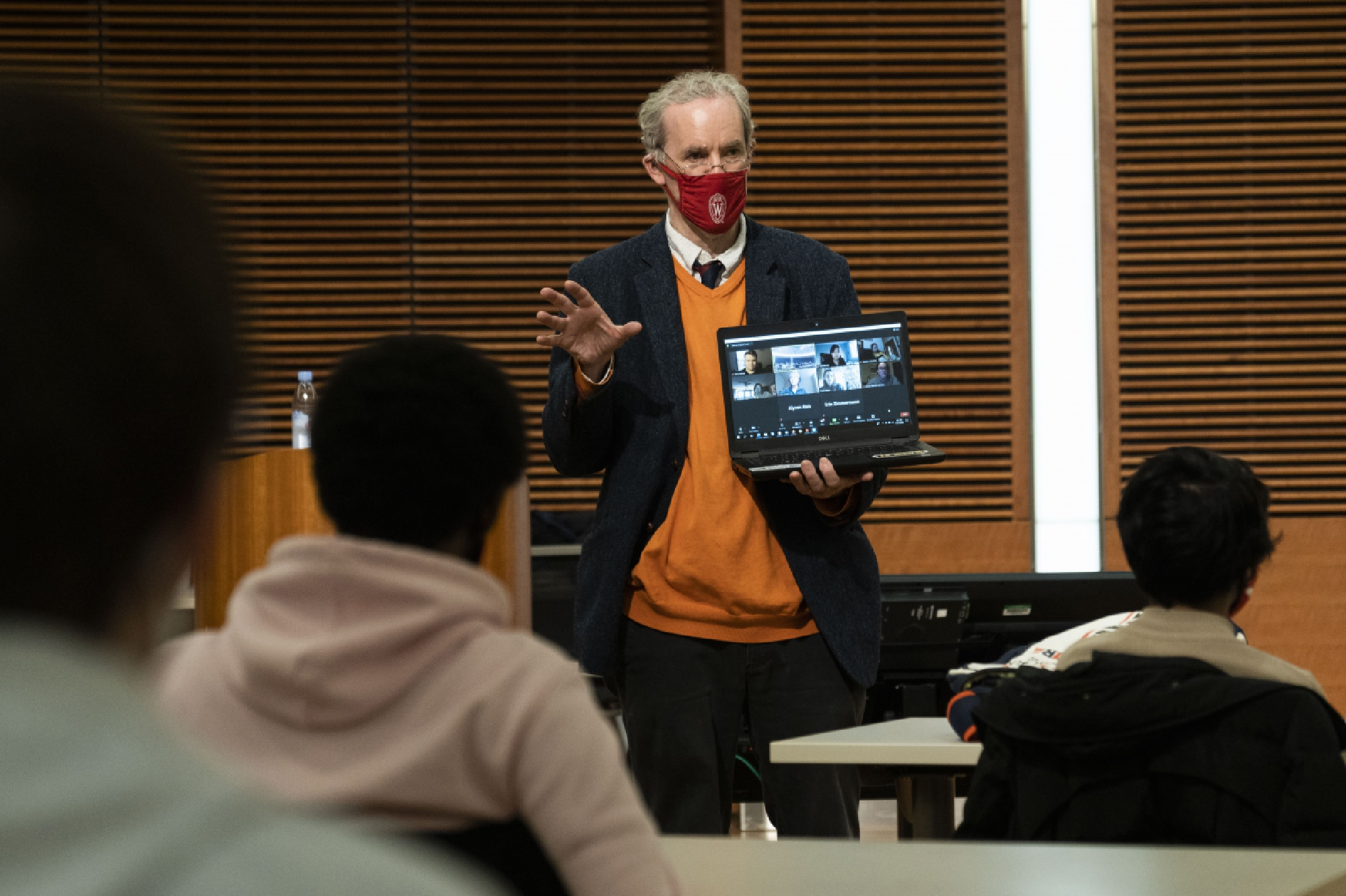Harry Brighouse, a professor of philosophy at the University of Wisconsin at Madison, teaches an in-person class. Some remote students join the discussion through video on Brighouse's laptop. MUST CREDIT: Photo for The Washington Post by Lauren Justice