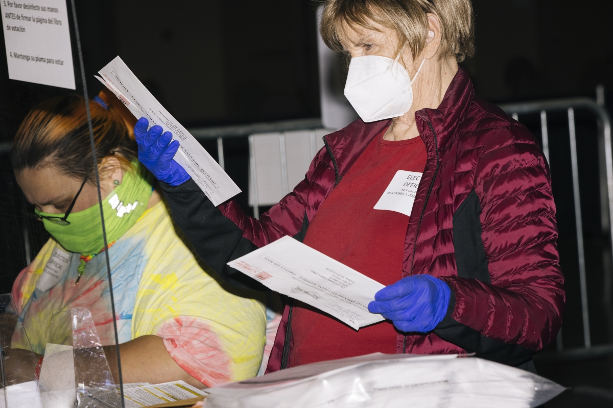 Election workers in Milwaukee examine ballots on Friday. MUST CREDIT: Photo for The Washington Post by Taylor Glascock