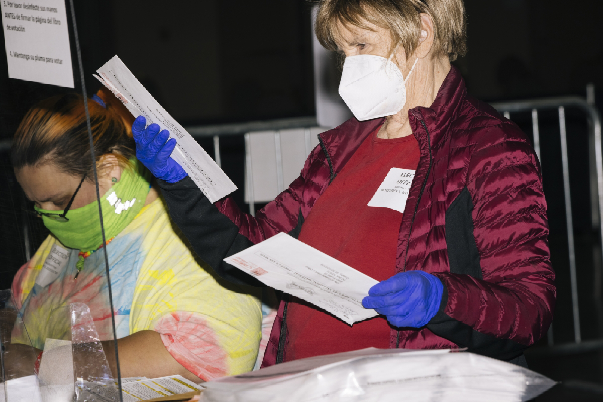 Election workers in Milwaukee examine ballots on Friday. MUST CREDIT: Photo for The Washington Post by Taylor Glascock