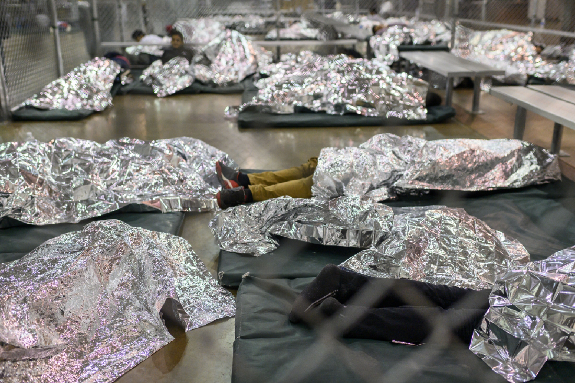 Male minors rest under Mylar blankets in the Border Patrol Central Processing Center in McAllen, Texas., in August 2019. MUST CREDIT: Washington Post photo by Carolyn Van Houten.