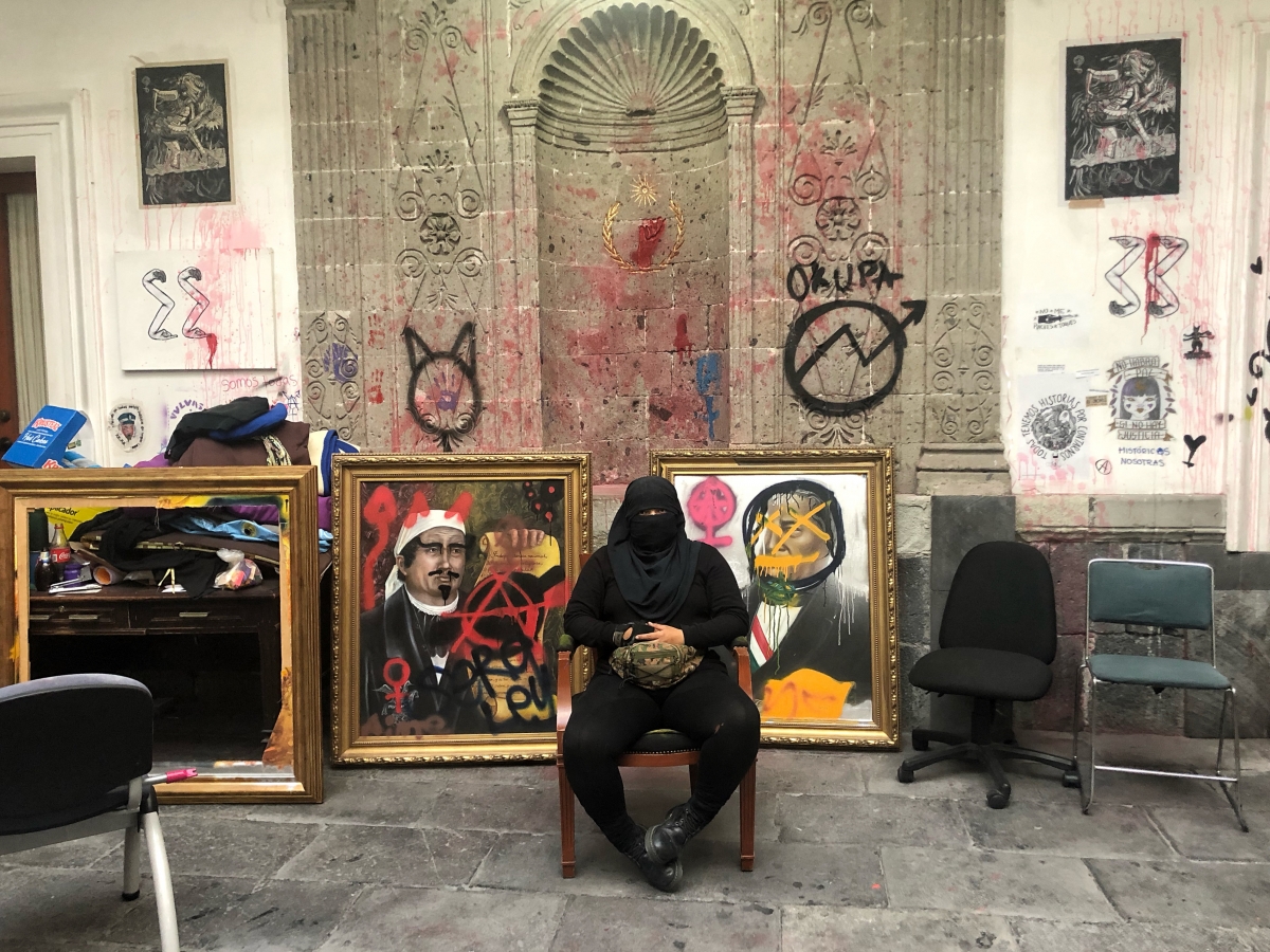 Doc, a member of feminist group Bloque Negro, is among the activists who have occupied the human rights office. She is seen in the courtyard of the Spanish colonial building in front of historic paintings the activists have defaced. MUST CREDIT: Washington Post photo by Marissa Lang