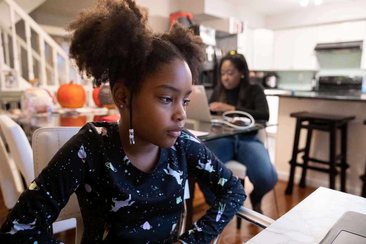 Karen James works in late October while her daughter Olivia attends virtual school at their home in Alexandria, Va. MUST CREDIT: Photo for The Washington Post by Amanda Andrade-Rhoades