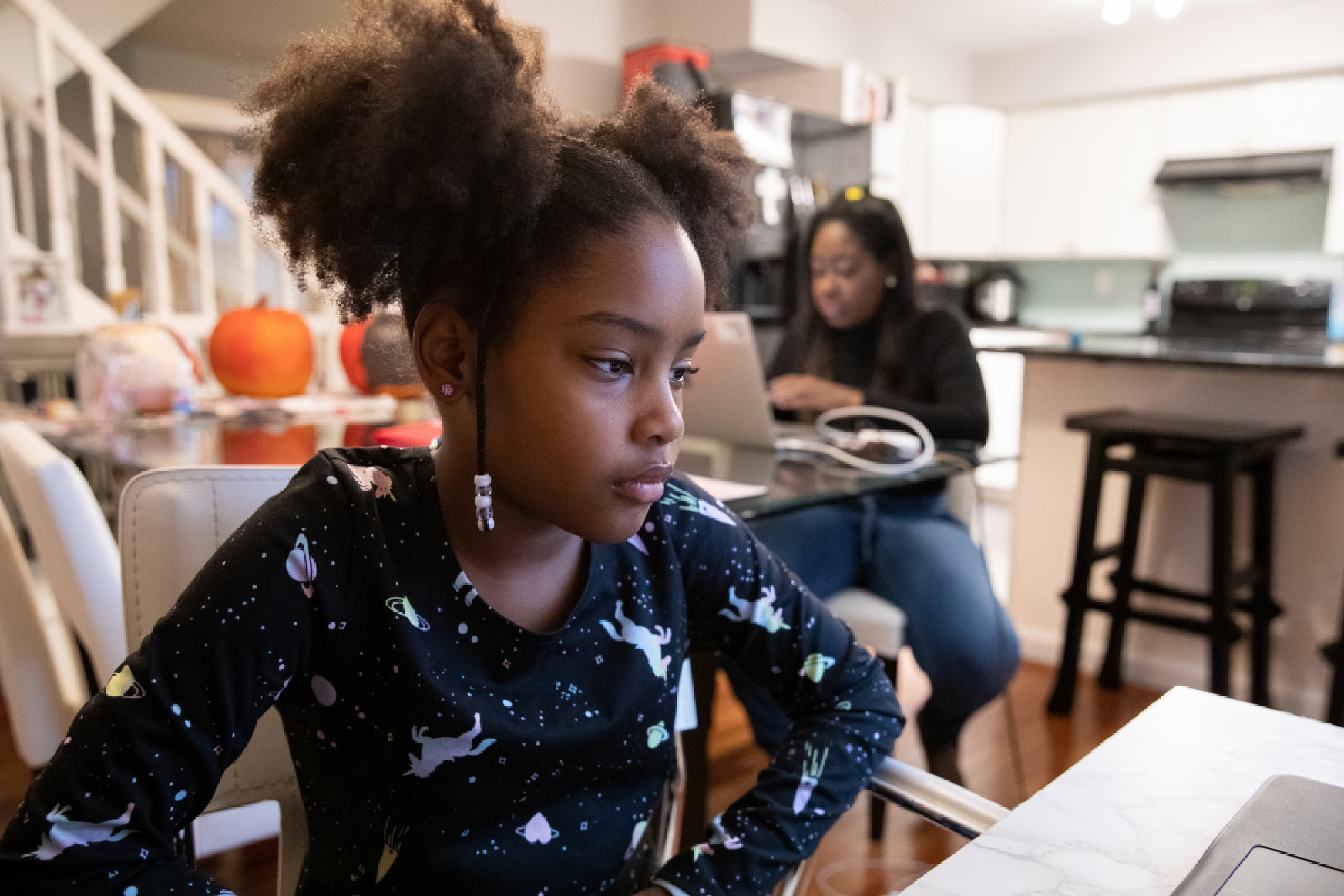 Karen James works in late October while her daughter Olivia attends virtual school at their home in Alexandria, Va. MUST CREDIT: Photo for The Washington Post by Amanda Andrade-Rhoades