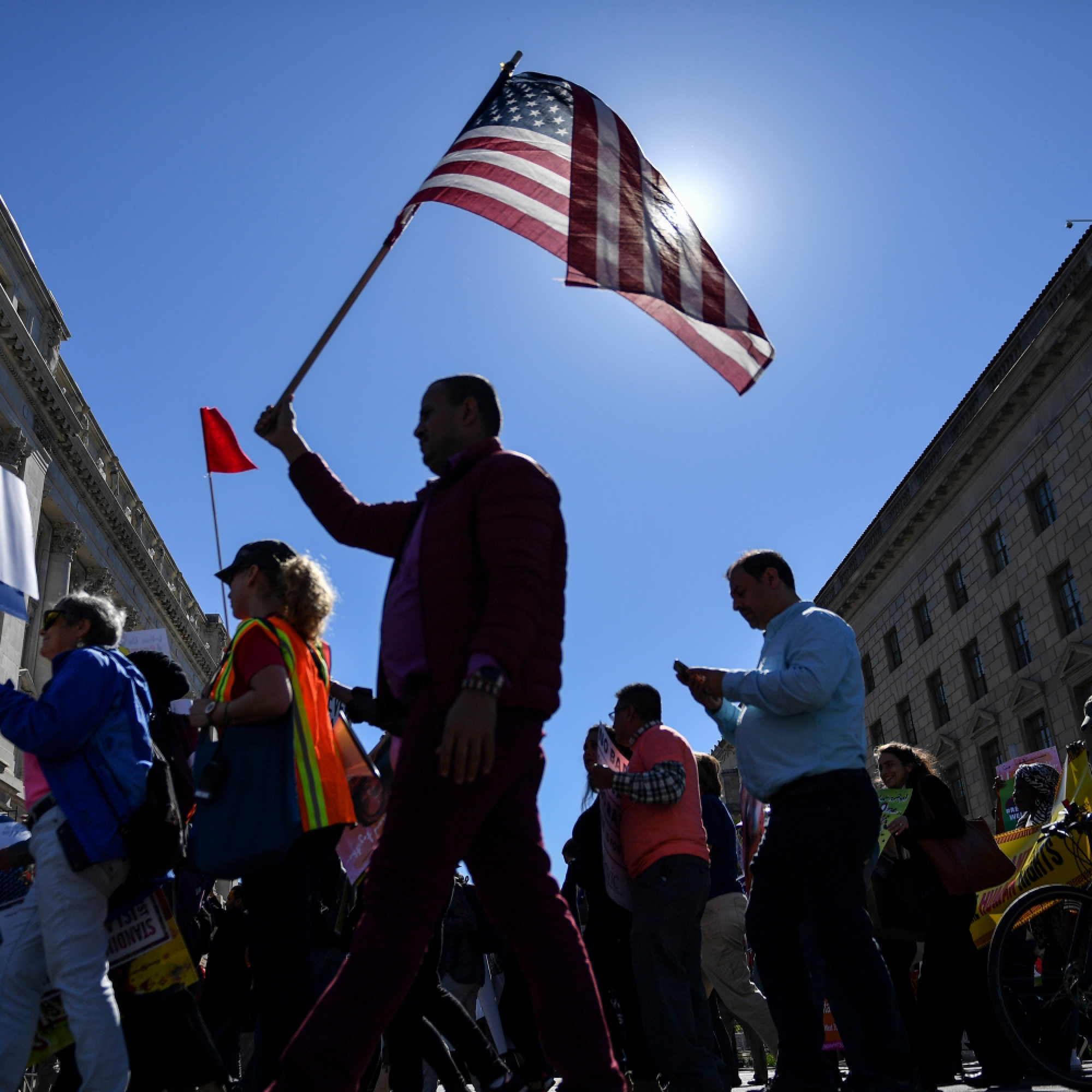 People take part in a "No Muslim Ban Ever" march and protest of the travel ban imposed by the Trump administration as they head toward the Trump International Hotel on Oct. 18, 2017, in Washington. MUST CREDIT: Washington Post photo by Ricky Carioti.