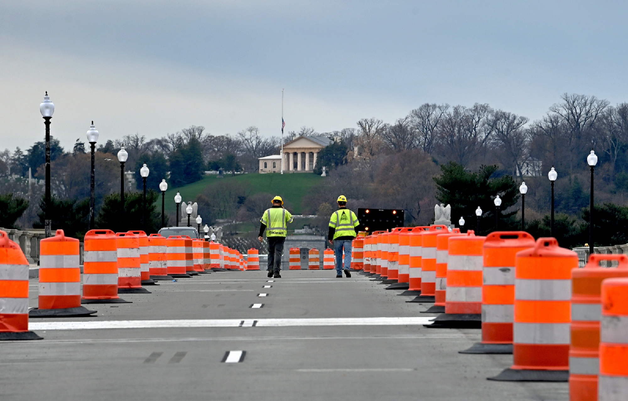 Workers walk the Arlington Memorial Bridge just before it opened to traffic Friday. The bridge over the Potomac River between Washington, D.C., and Arlington, Va., reopened after a two-year, $227 million rehabilitation project that had disrupted traffic on one of Washington's most heavily used and historic spans. MUST CREDIT: Washington Post photo by Michael S. Williamson