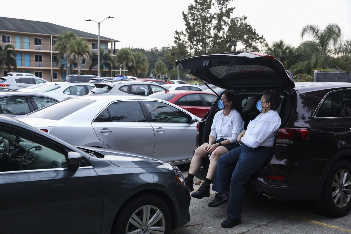 Kelly Madison, left, and Lori Mannel wait for food at the Seasons Florida Resort. MUST CREDIT: Photo by Eve Edelheit for The Washington Post.