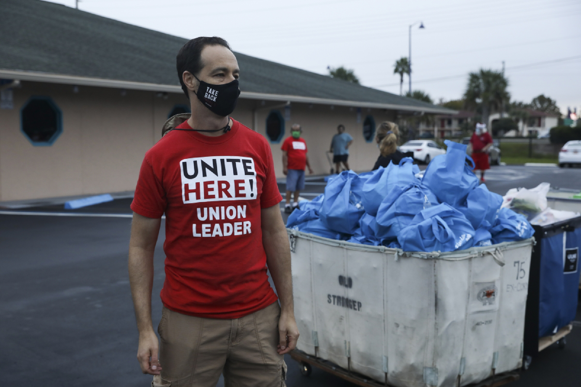 Unite Here Local 737 President Jeremy Haicken helps out at Saturday's food drive at the Seasons Florida Resort in Kissimmee. MUST CREDIT: Photo by Eve Edelheit for The Washington Post.