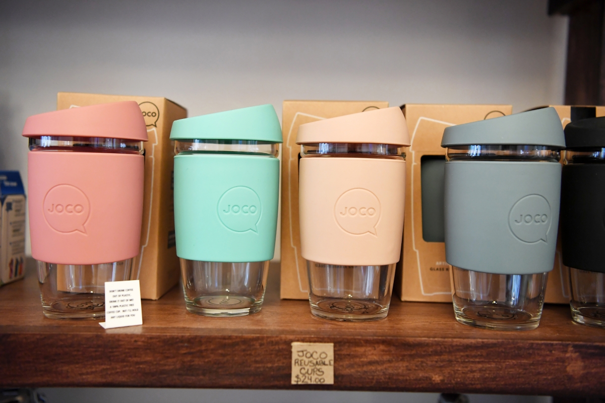 Glass travel coffee mugs are among the many reusable items at Mason & Greens. MUST CREDIT: Washington Post photo by Matt McClain
