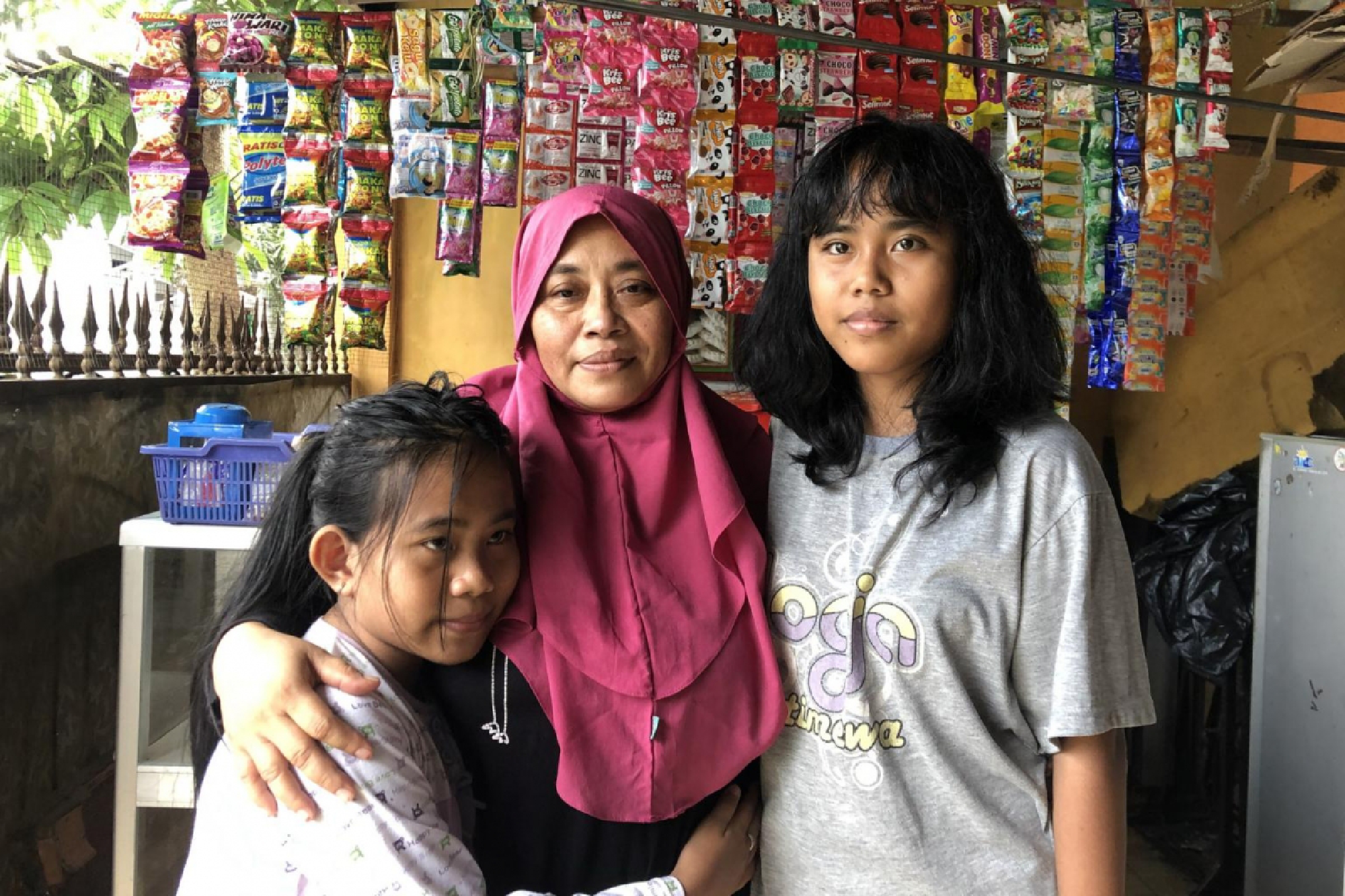 Madam Suyatni and her daughters at her home outside Jakarta. ST PHOTO: JEFF HUTTON