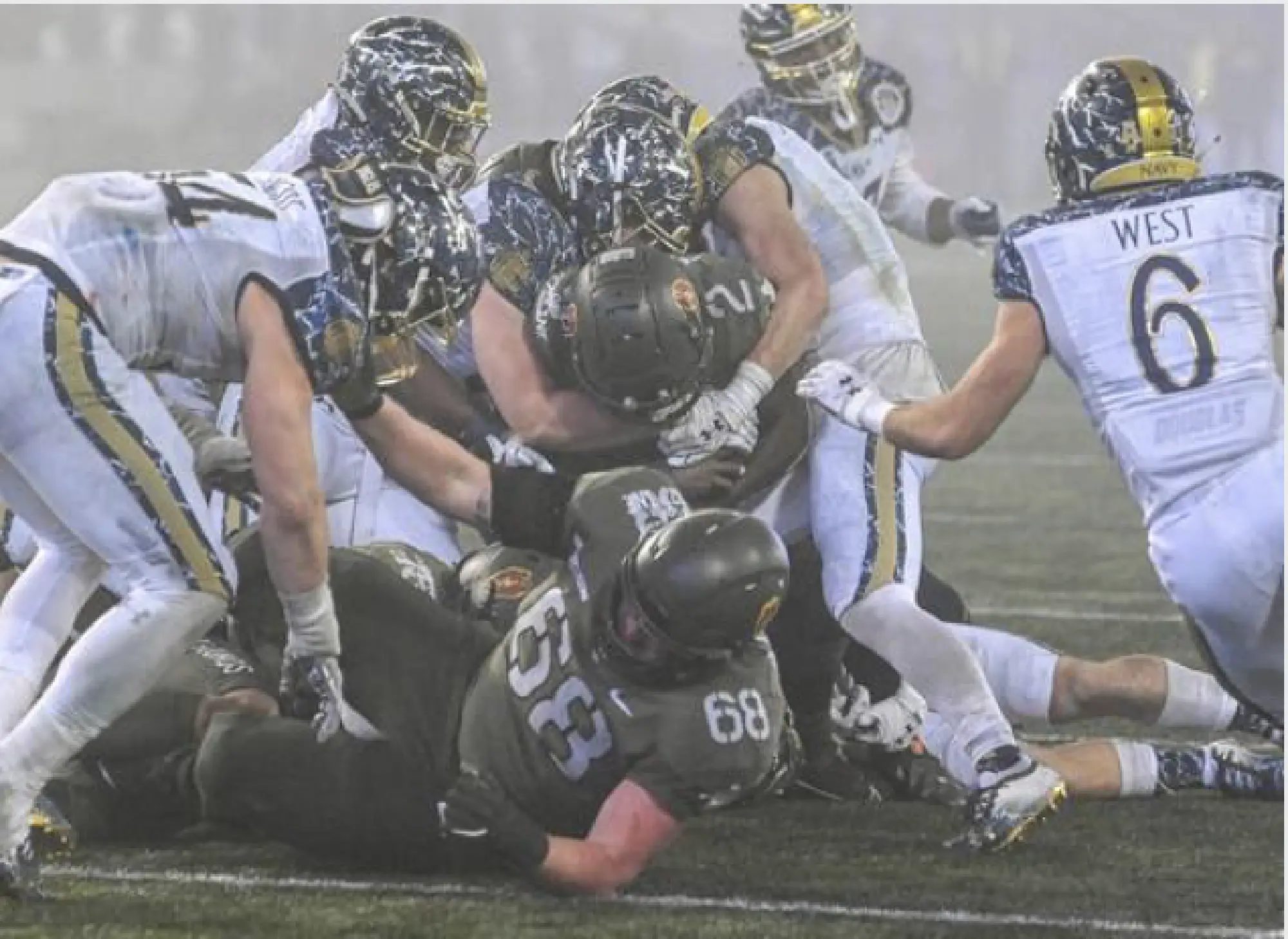Army Black Knights quarterback Tyhier Tyler (2) pounds his way inside the 20-yard line during fourth quarter of Saturday's game againt Navy. Tyler had the lone touchdown of the game as Army prevailed 15-0. MUST CREDIT: Washington Post photo by Jonathan Newton