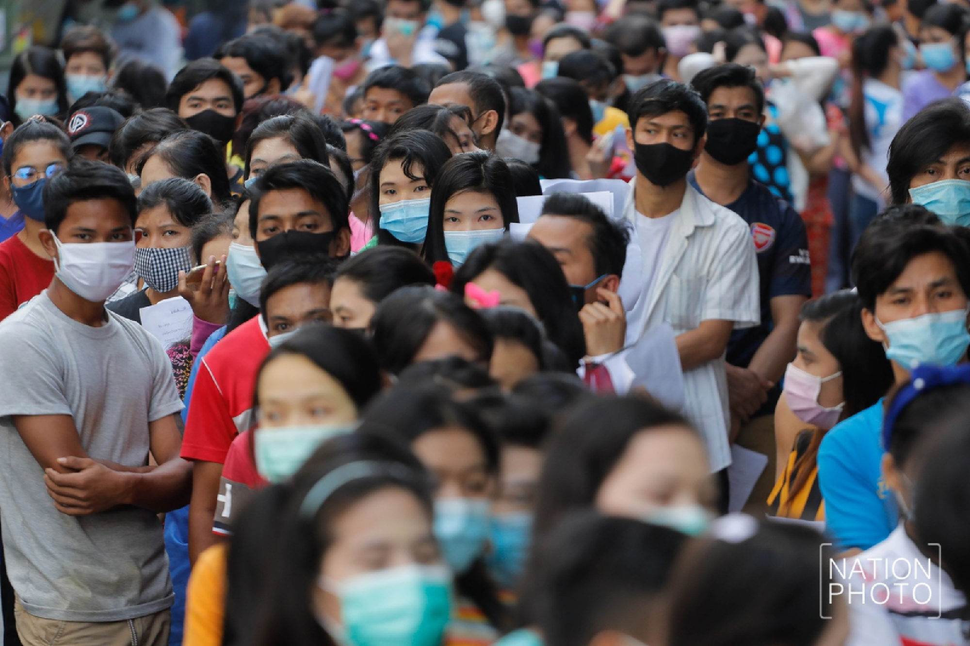 Thousands of Burmese workers Including some Thai people waiting in line for COVID-19 screening Inside the Thai Union Market, Samut Sakhon Province.