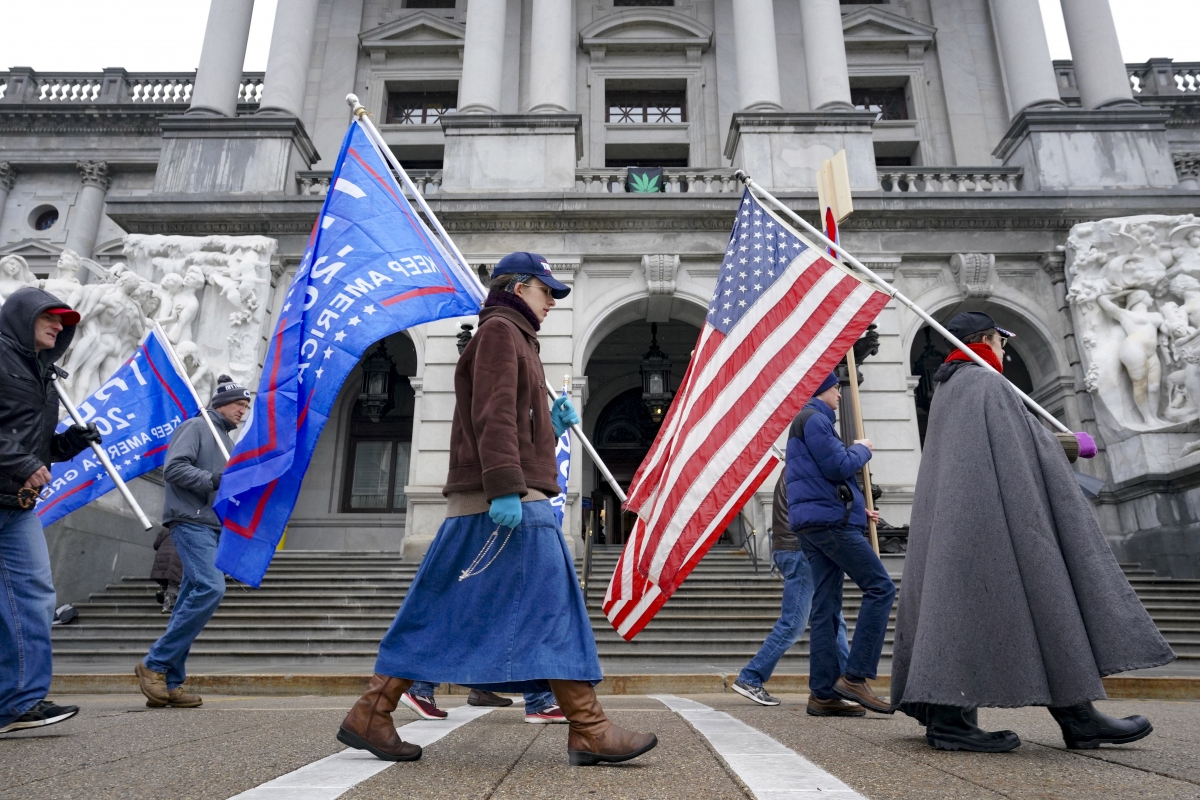 Trump supporters pray and sing during a demonstrations outside the Pennsylvania Capitol in Harrisburg on Monday, Dec. 14, 2020. MUST CREDIT: Washington Post photo by Bonnie Jo Mount