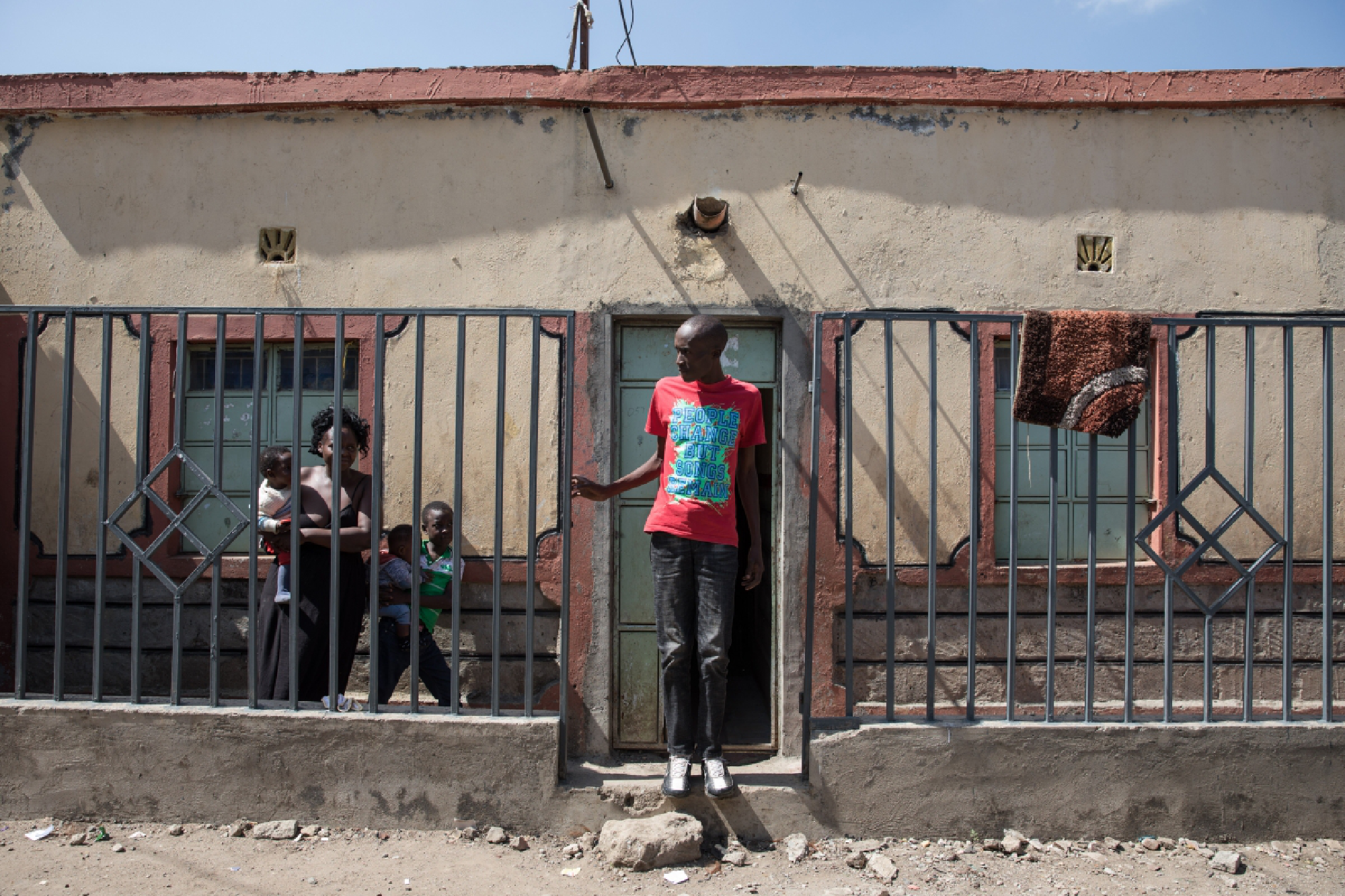 Francis Otieno stands outside his house in a Nairobi ghetto. MUST CREDIT: Photo for The Washington Post by Sarah Waiswa
