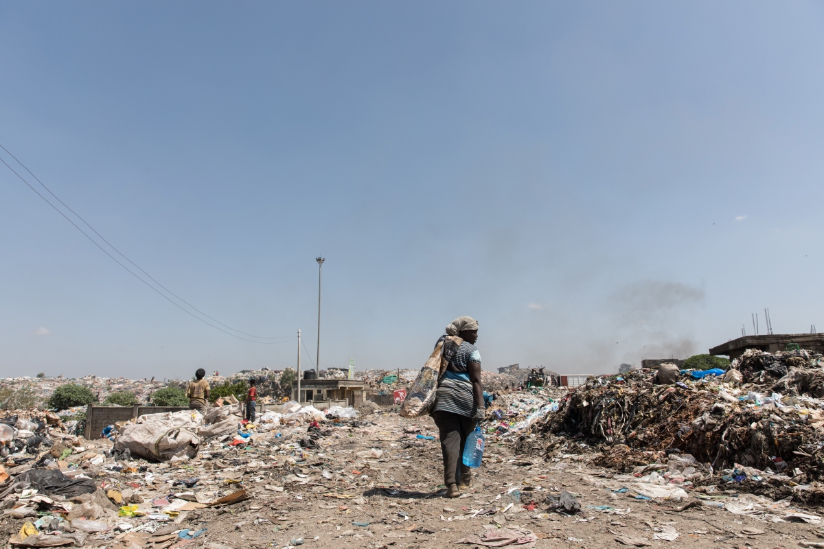 A woman walks through the dump site where Ibrahim Onyango, Francis's brother, worked before he was killed in March. MUST CREDIT: Photo for The Washington Post by Sarah Waiswa