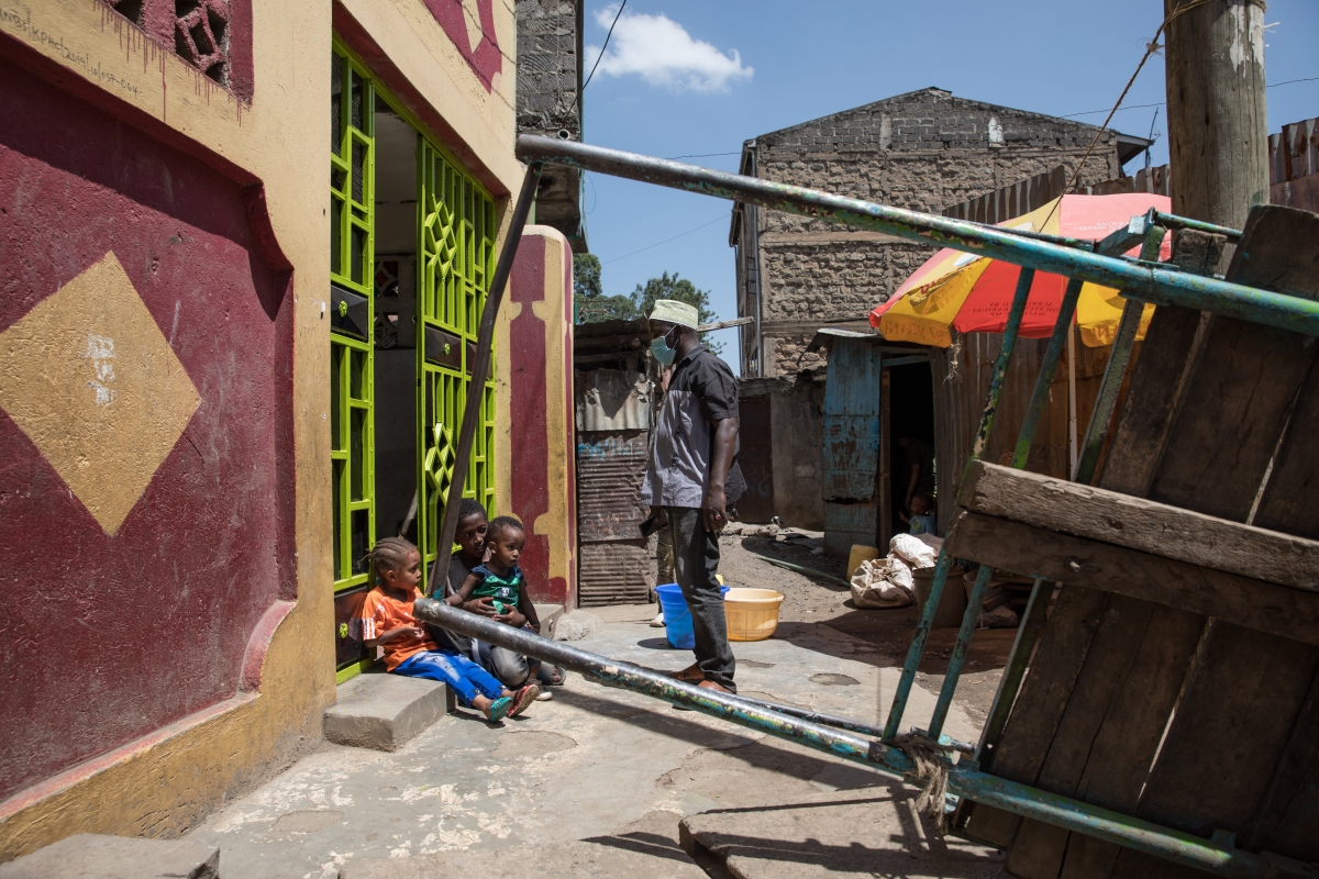 Hussein Moyo Molte talks to his three young children outside their home in Nairobi. MUST CREDIT: Photo for The Washington Post by Sarah Waiswa