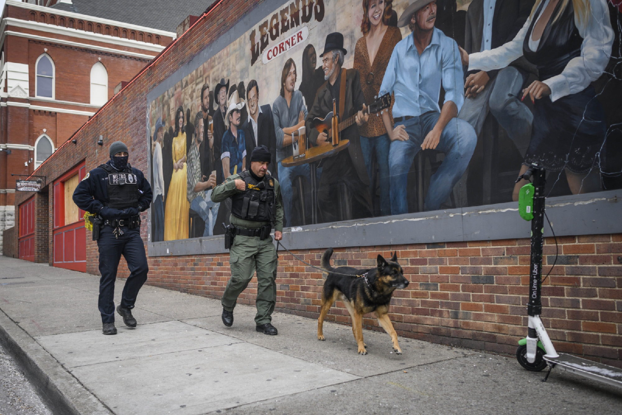  Police and a bomb-sniffing dog investigate an explosion Friday, Dec. 25, 2020. Photo for The Washington Post by William DeShazer 