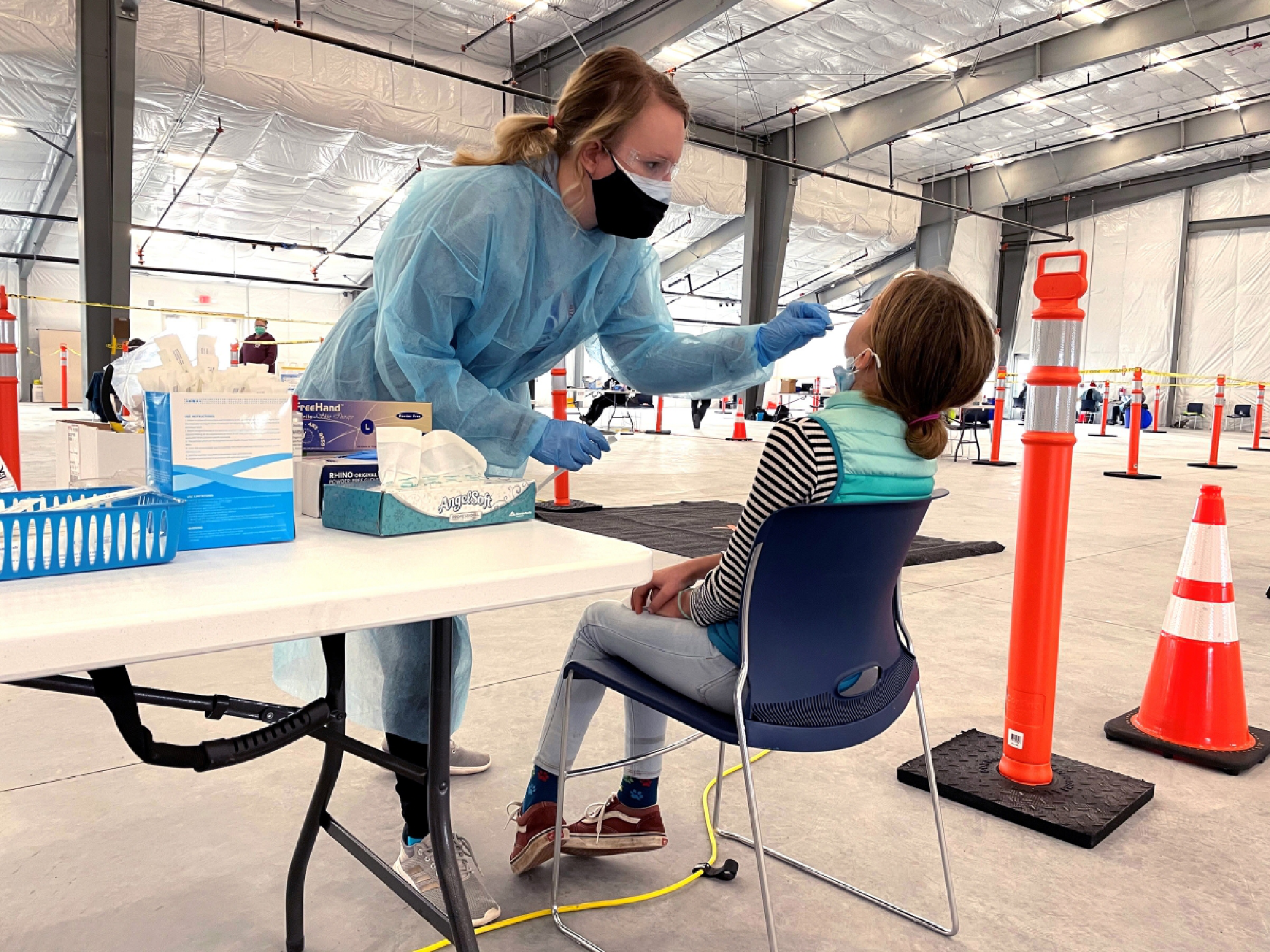 Jessica Carey, a school nurse, swabs an asymptomatic child at Garrett County's public testing site. Carey will be among the first to get the vaccine so she can compose a blog to help persuade a reluctant community to get vaccinated. MUST CREDIT: Washington Post photo by Erin Cox