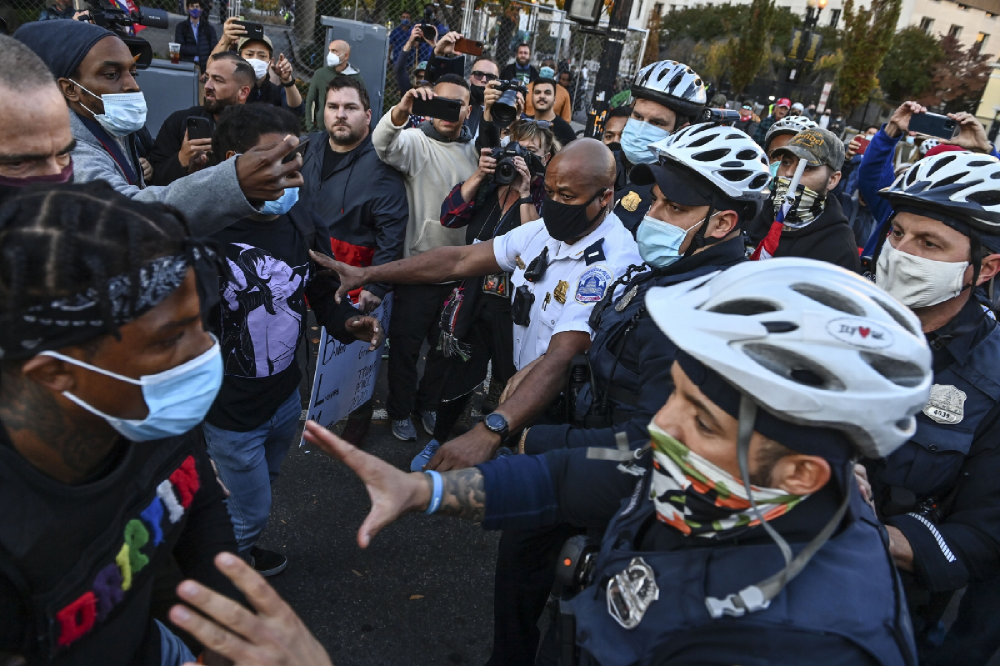  Police break up a scuffle between anti-Trump and pro-Trump demonstrators at Black Lives Matter Plaza on Nov. 13, 2020, in Washington, D.C. Washington Post photo by Ricky Carioti 