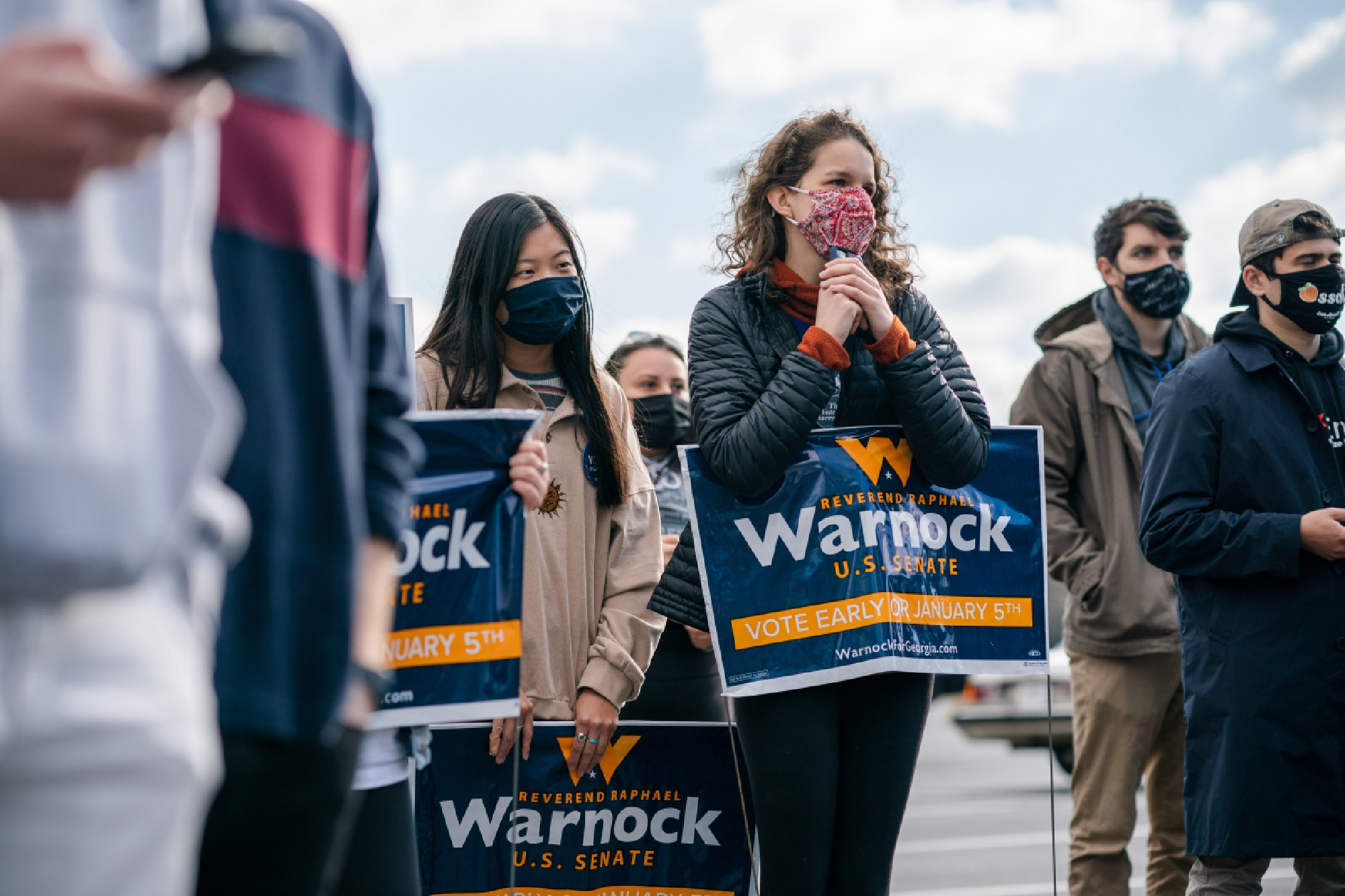 Canvassers listen to Democrat Raphael Warnock in Marietta, Ga., on Tuesday. MUST CREDIT: photo for The Washington Post by Kevin D. Liles.