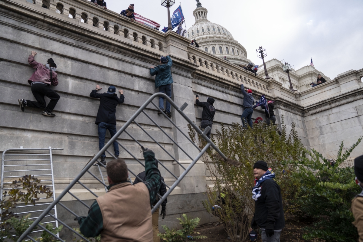 Trump supporters scale the walls on the Senate side of the Capitol on Wednesday, Jan. 6, 2021. MUST CREDIT: Washington Post photo by Michael Robinson Chavez
