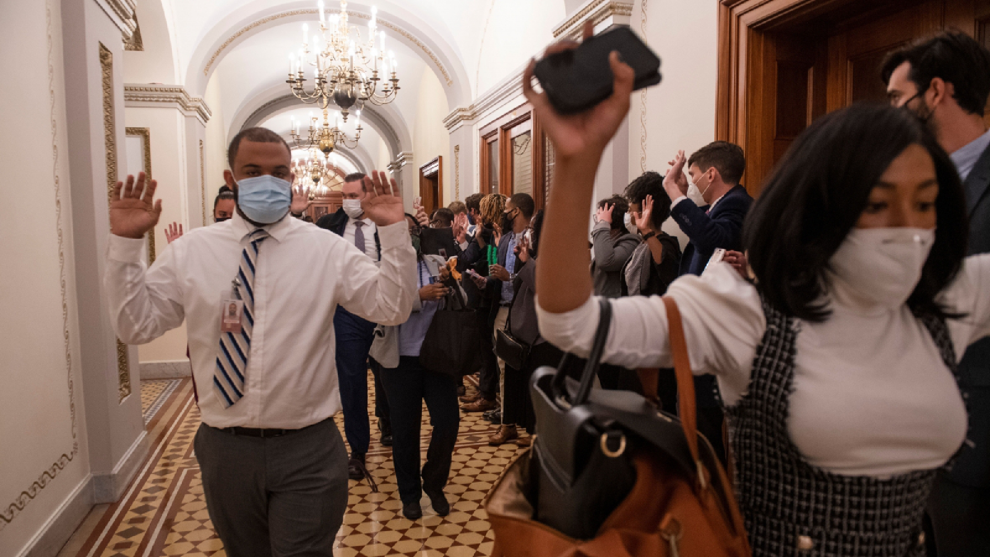 Congressional staff members are ushered out of the Capitol after a mob of rioters breached the building on Wednesday, Jan. 6, 2021. MUST CREDIT: Photo for The Washington Post by Amanda Voisard