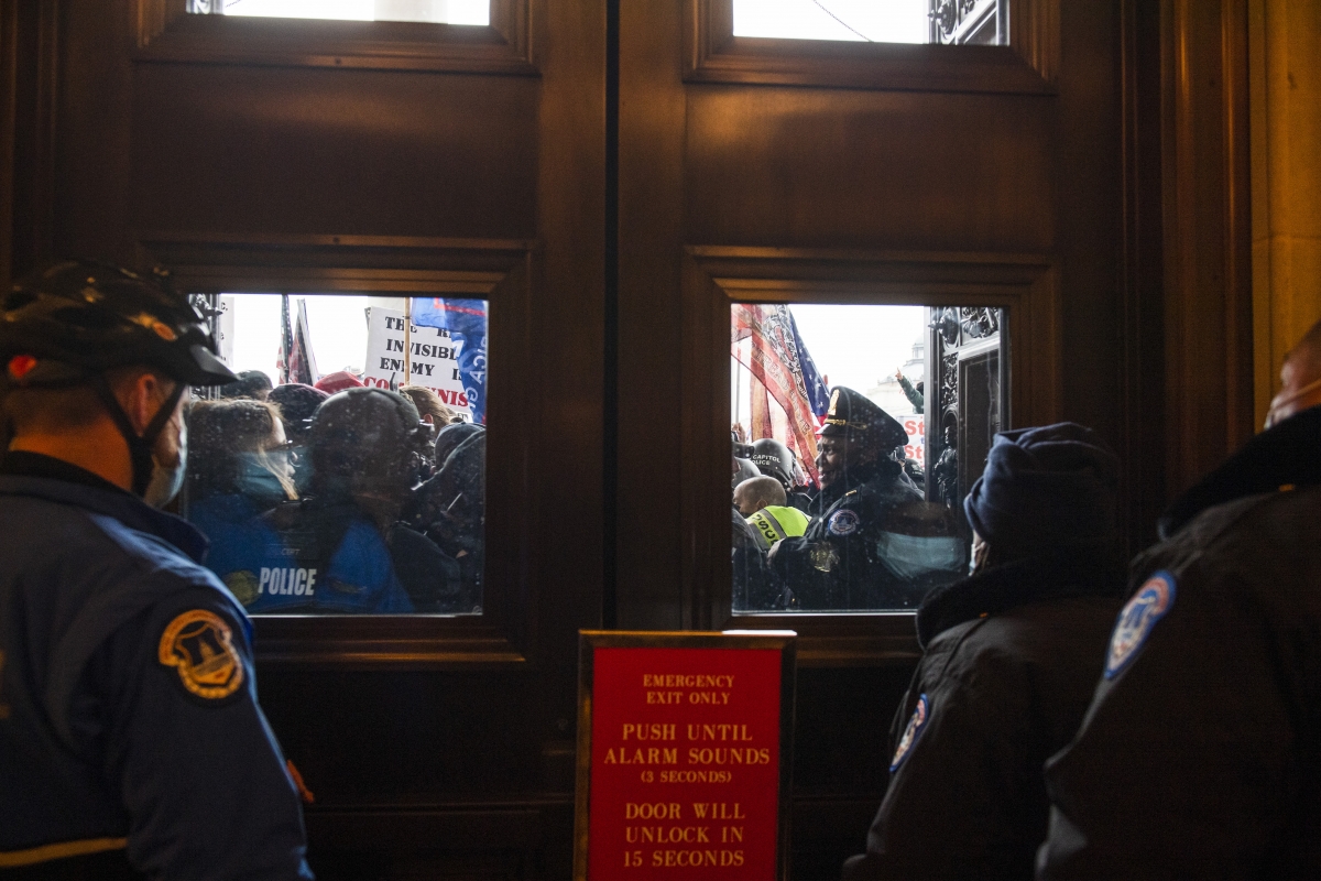 Rioters fight for access to the U.S. Capitol during a joint congressional session to certify the electoral college vote in Washington, D.C. on Jan. 6, 2021. MUST CREDIT: Photo for The Washington Post by Amanda Voisard
