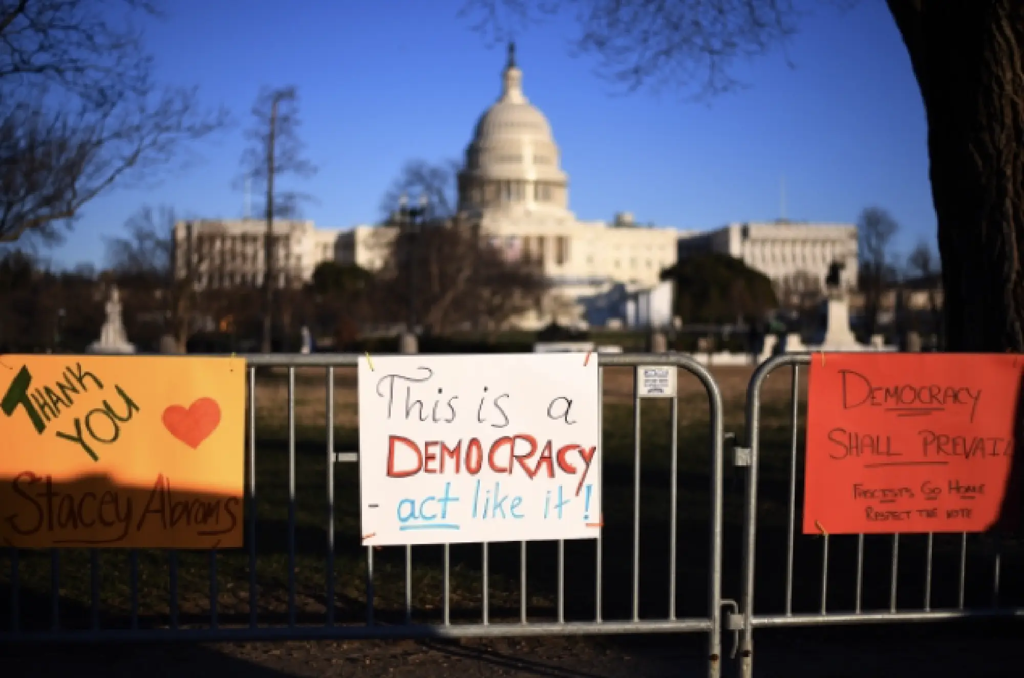 Pro-democracy signs line a fence near the U.S. Capitol in Washington on Jan. 9, three days after the building was invaded and vandalized by Trump-supporting rioters. MUST CREDIT: Photo for the Washington Post by Astrid Riecken