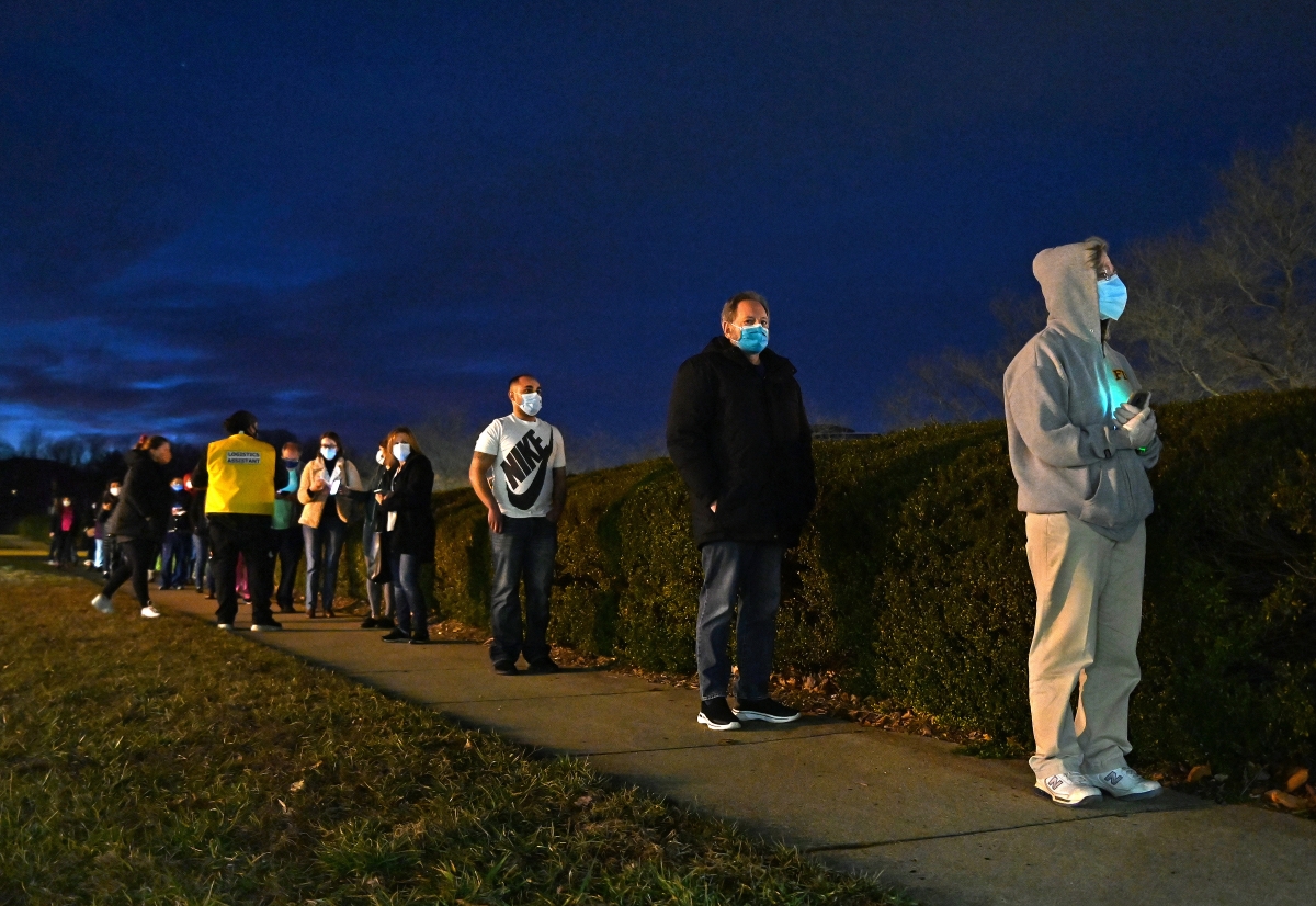 Health-care workers (some with appointments after dusk) wait in line to get coronavirus vaccines at the Fairfax County Government Center in Fairfax, Va., on Jan. 2. MUST CREDIT: Washington Post photo by Michael S. Williamson.